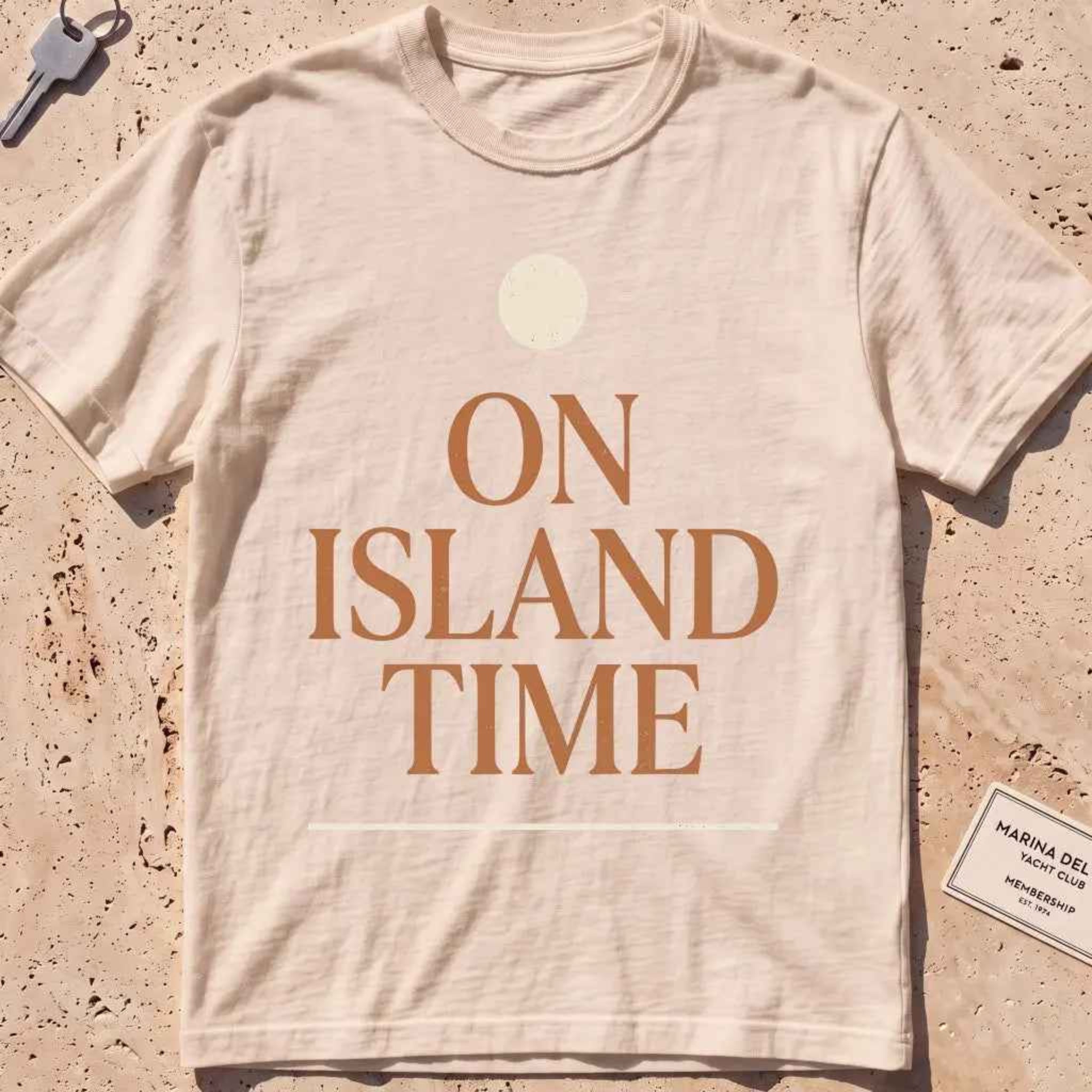 ivory heavyweight tee with terracotta "On Island Time" type and sun disc.