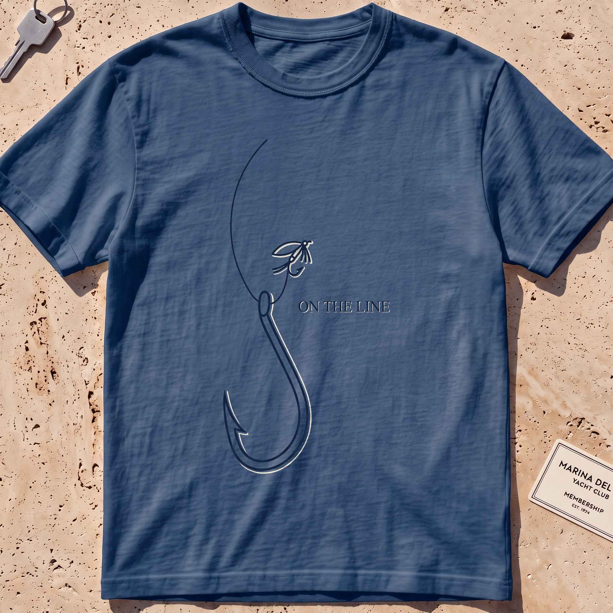 midnight heavyweight tee with a single-line fishing hook and fly graphic.