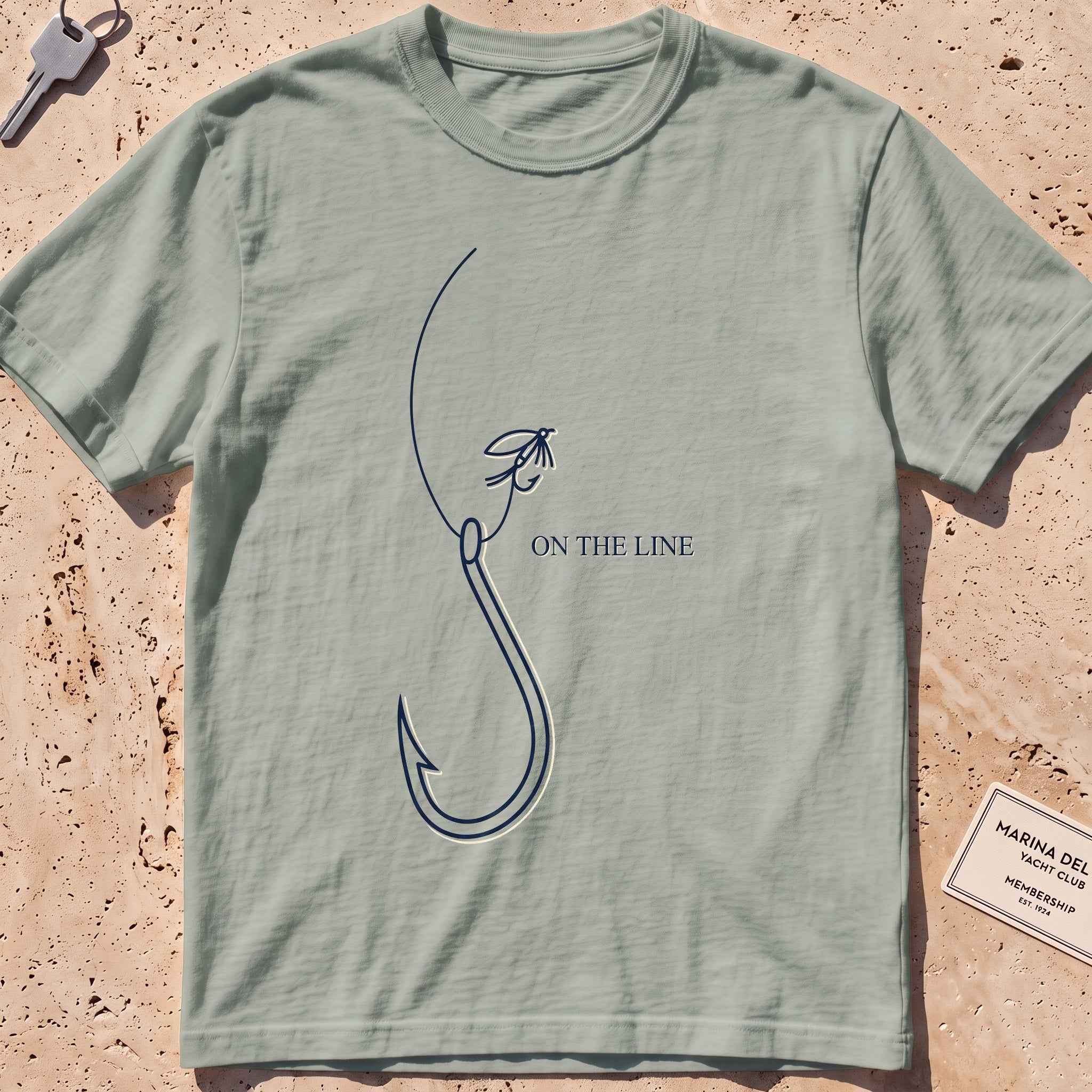 bay heavyweight tee with a single-line fishing hook and fly graphic.