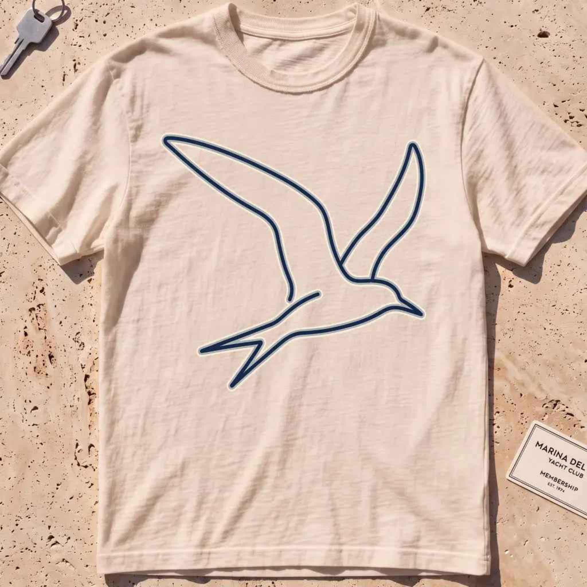 ivory heavyweight tee with a wordless continuous-line tern in flight.