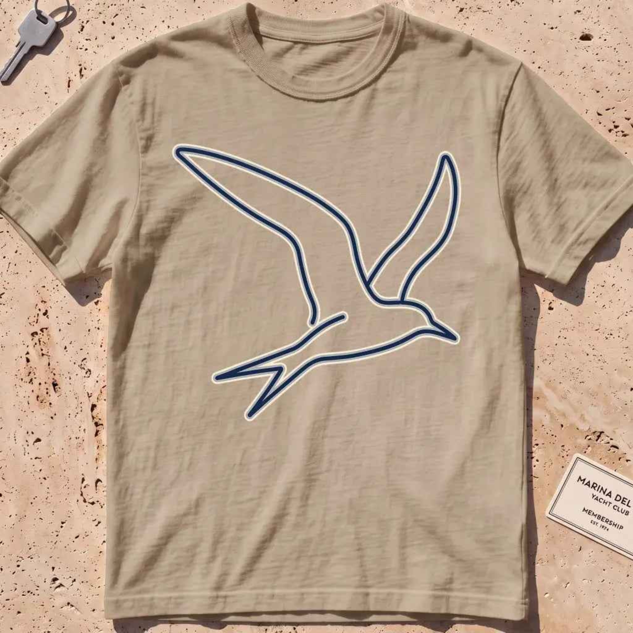 khaki heavyweight tee with a wordless continuous-line tern in flight.