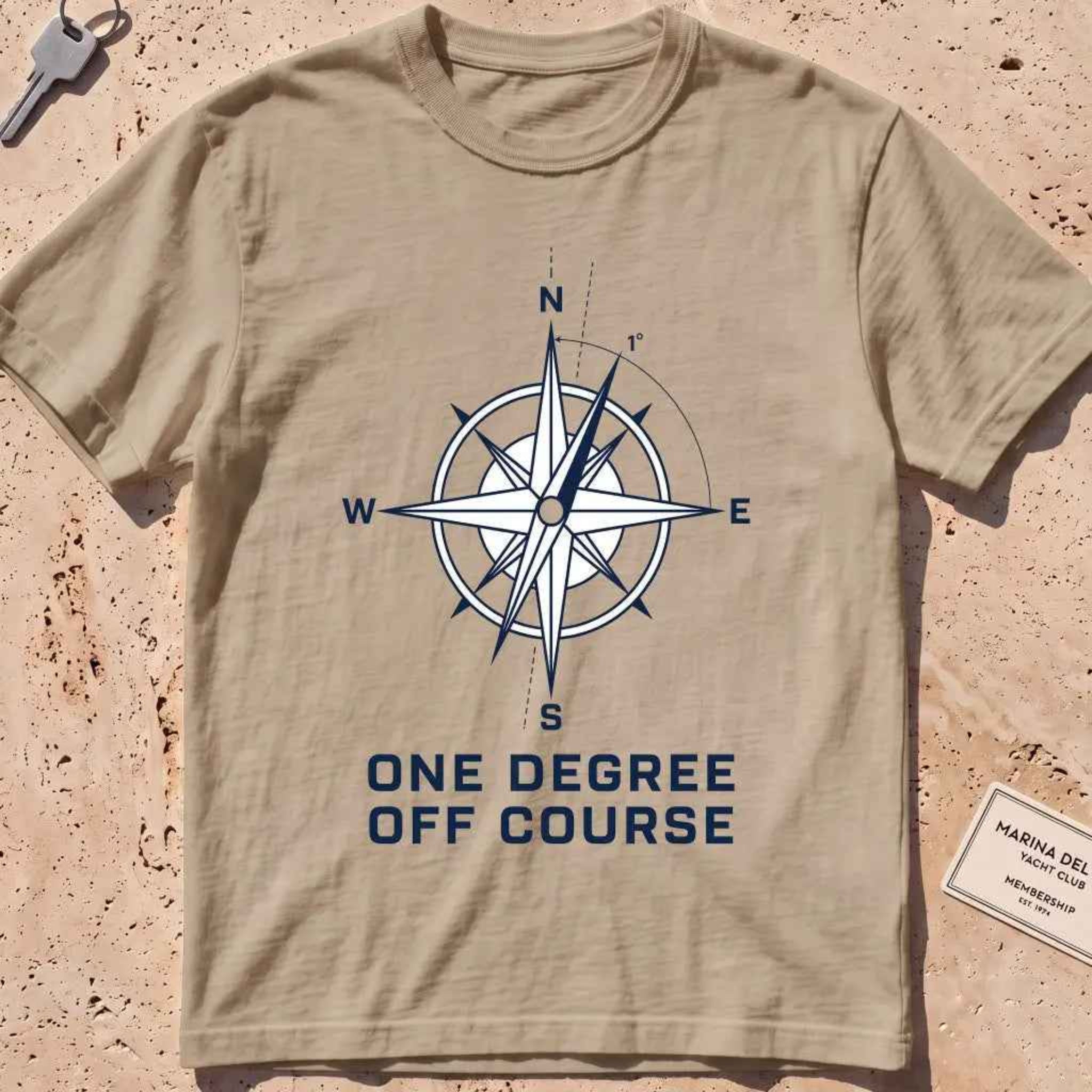 khaki heavyweight tee with a compass rose "One Degree Off Course" graphic.