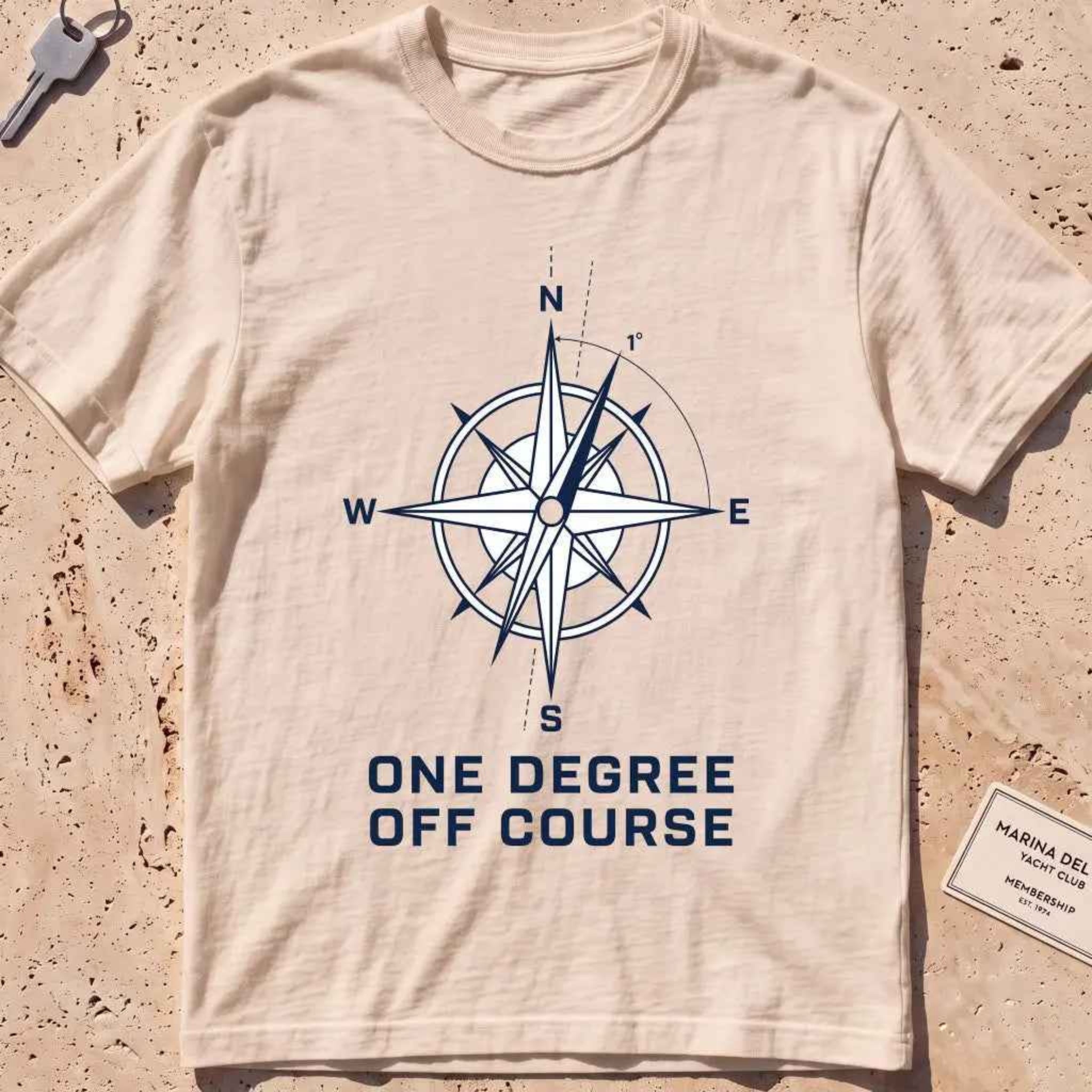 ivory heavyweight tee with a compass rose "One Degree Off Course" graphic.