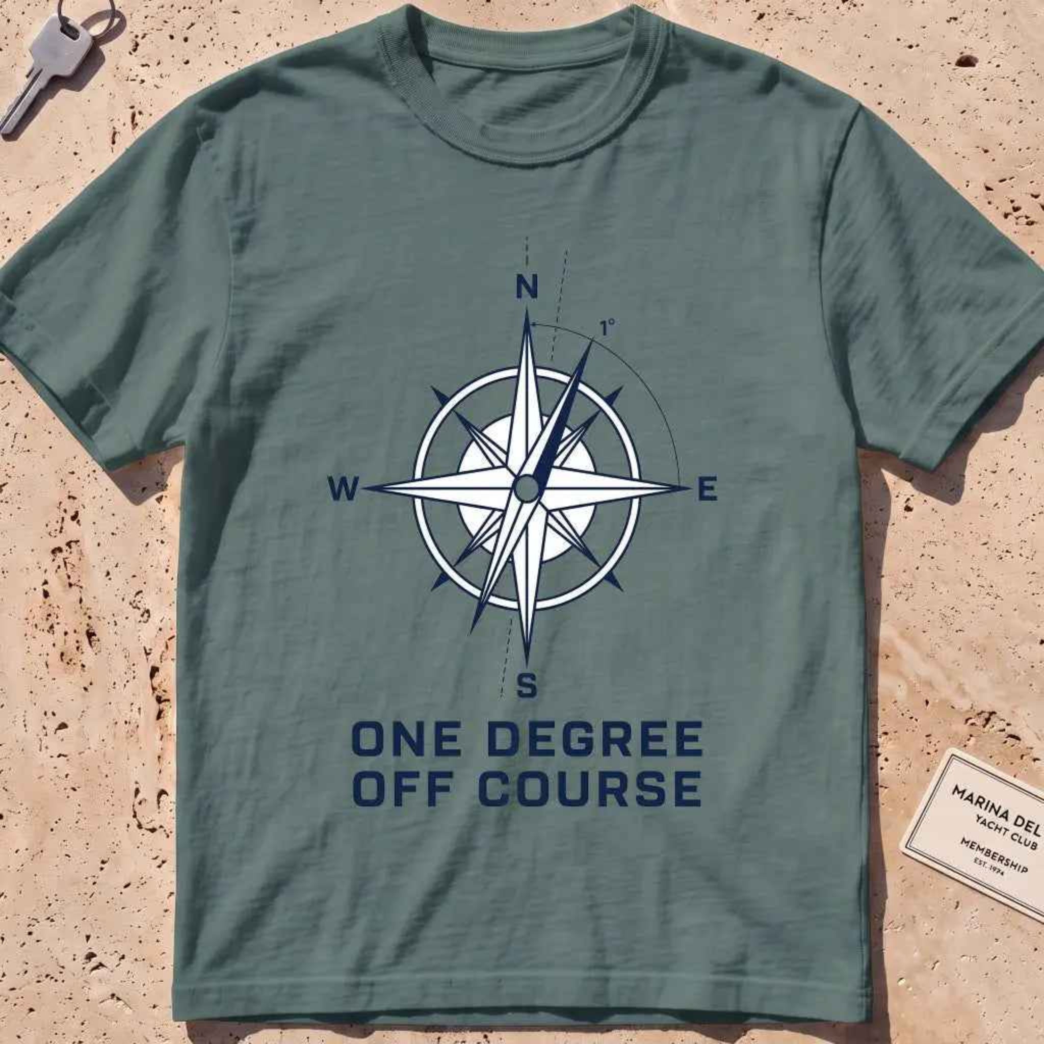 blue spruce heavyweight tee with a compass rose "One Degree Off Course" graphic.
