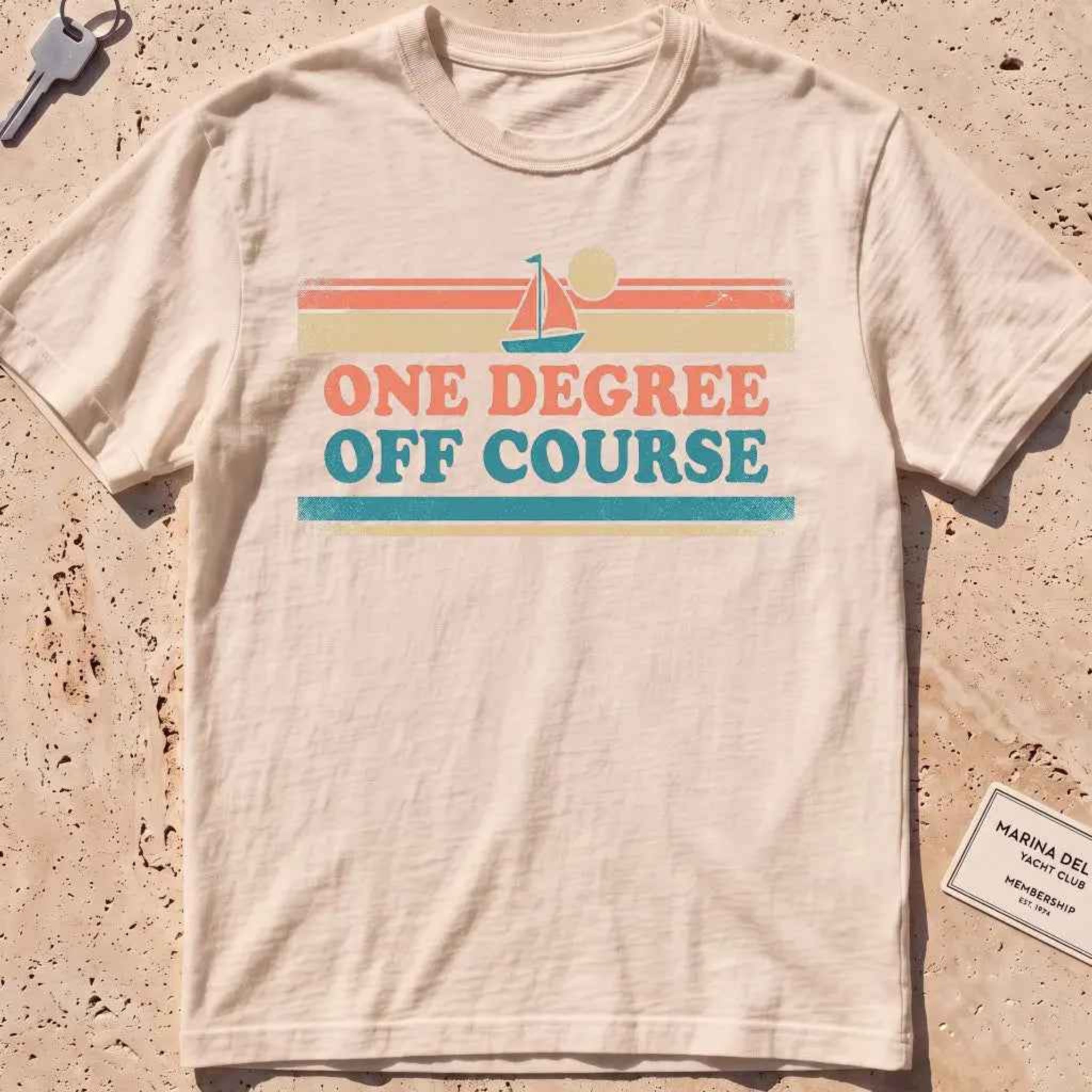 ivory heavyweight tee with retro stripes and "One Degree Off Course" text.