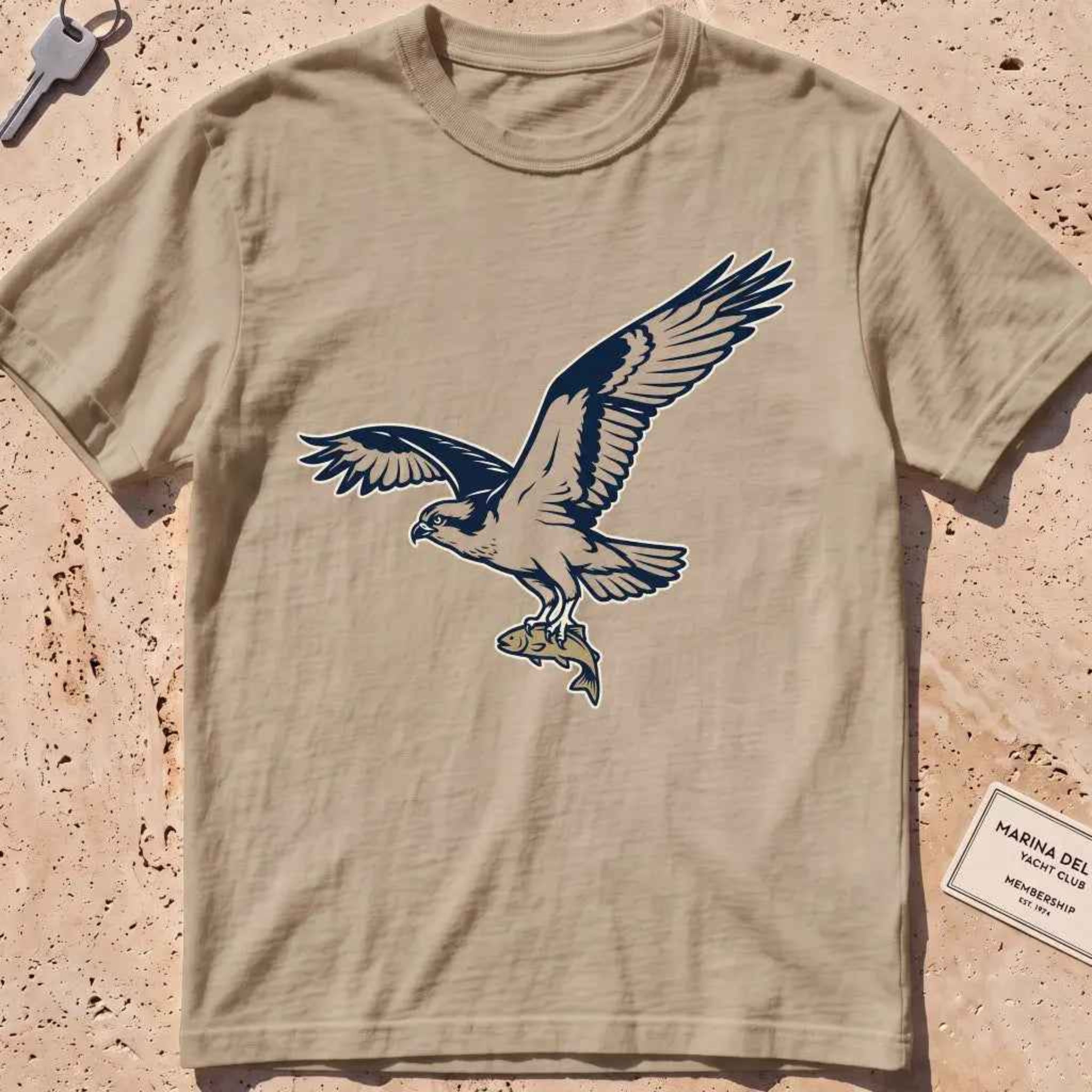khaki heavyweight tee with a bold-fill osprey carrying a fish in its talons graphic.