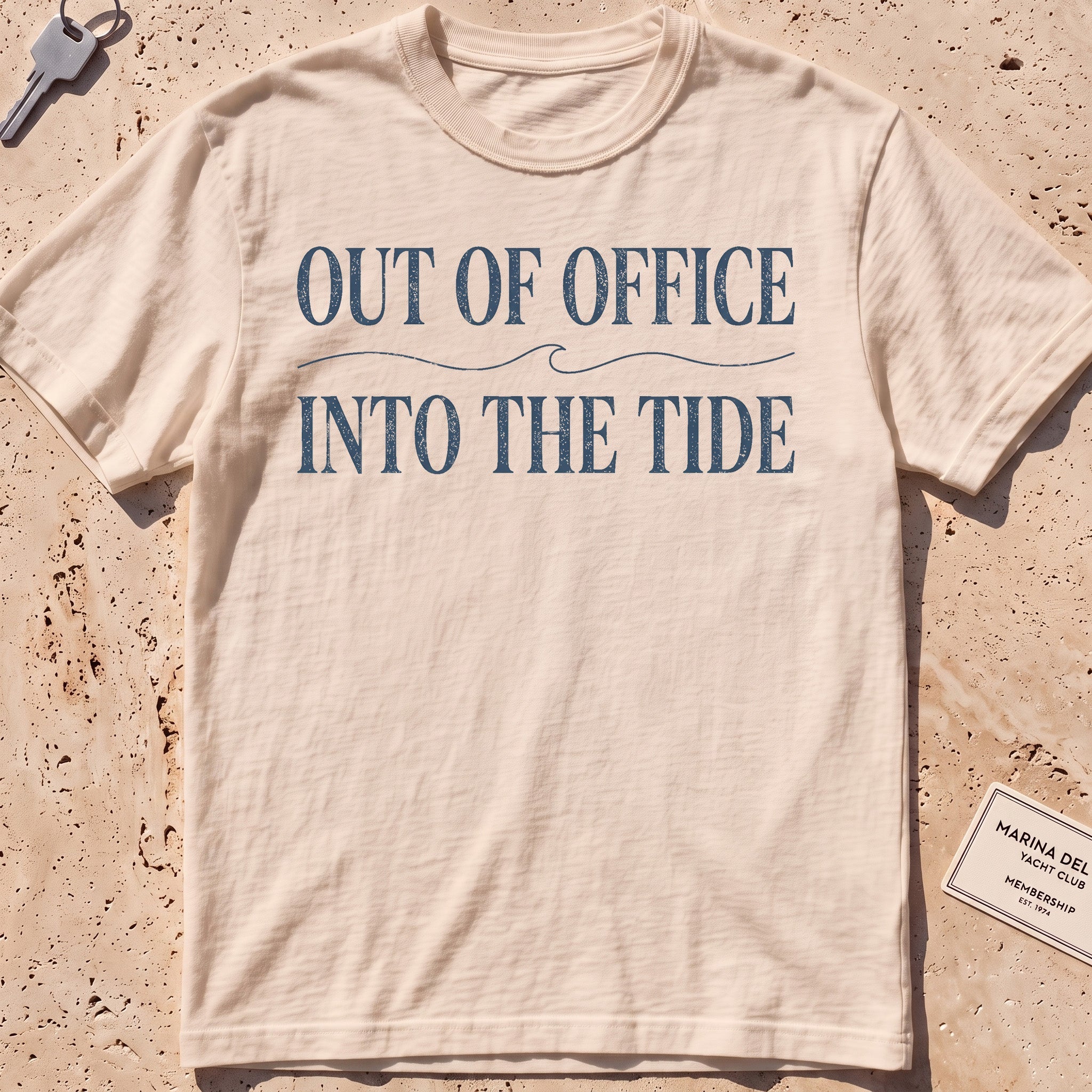 ivory heavyweight tee with "Out of Office Into the Tide" type over a wave.