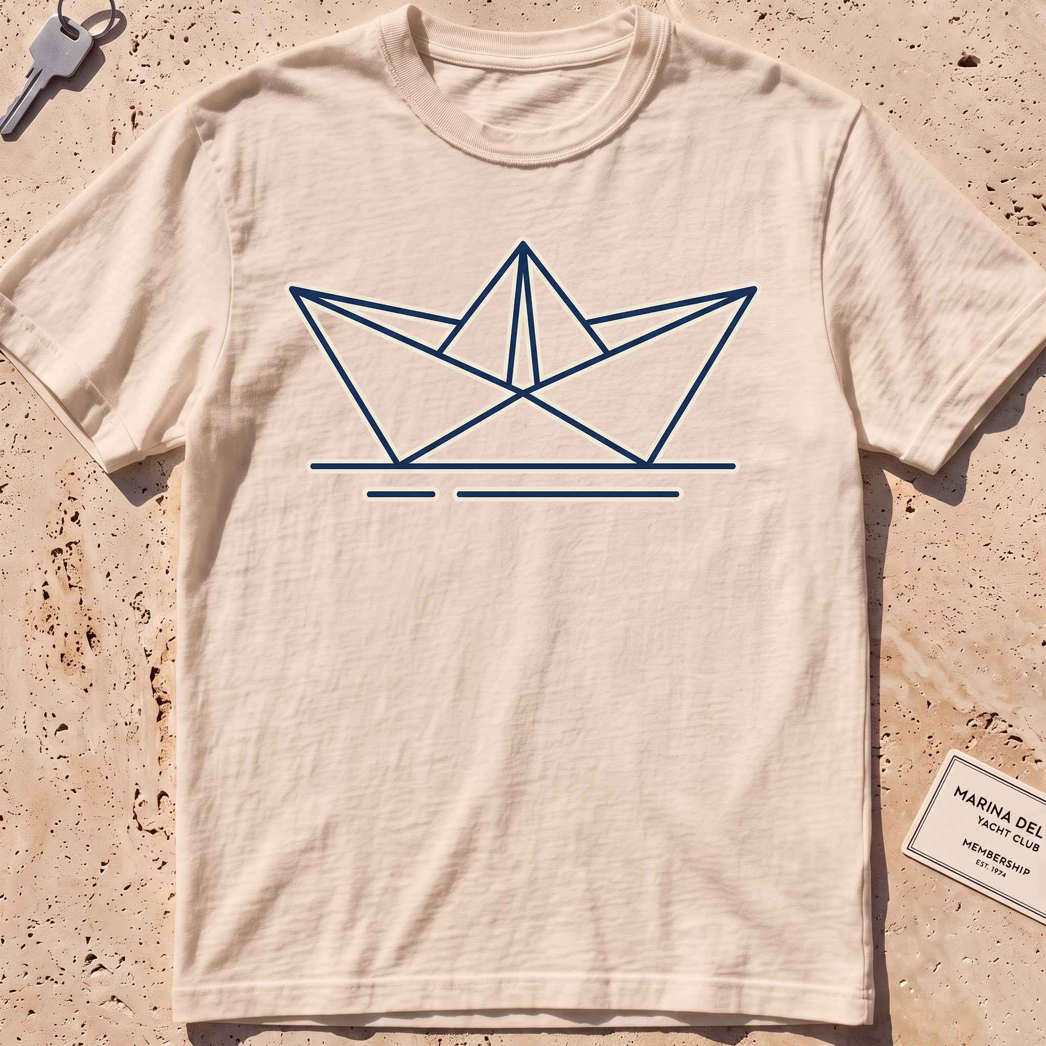 ivory heavyweight tee with a minimalist folded paper-boat graphic.