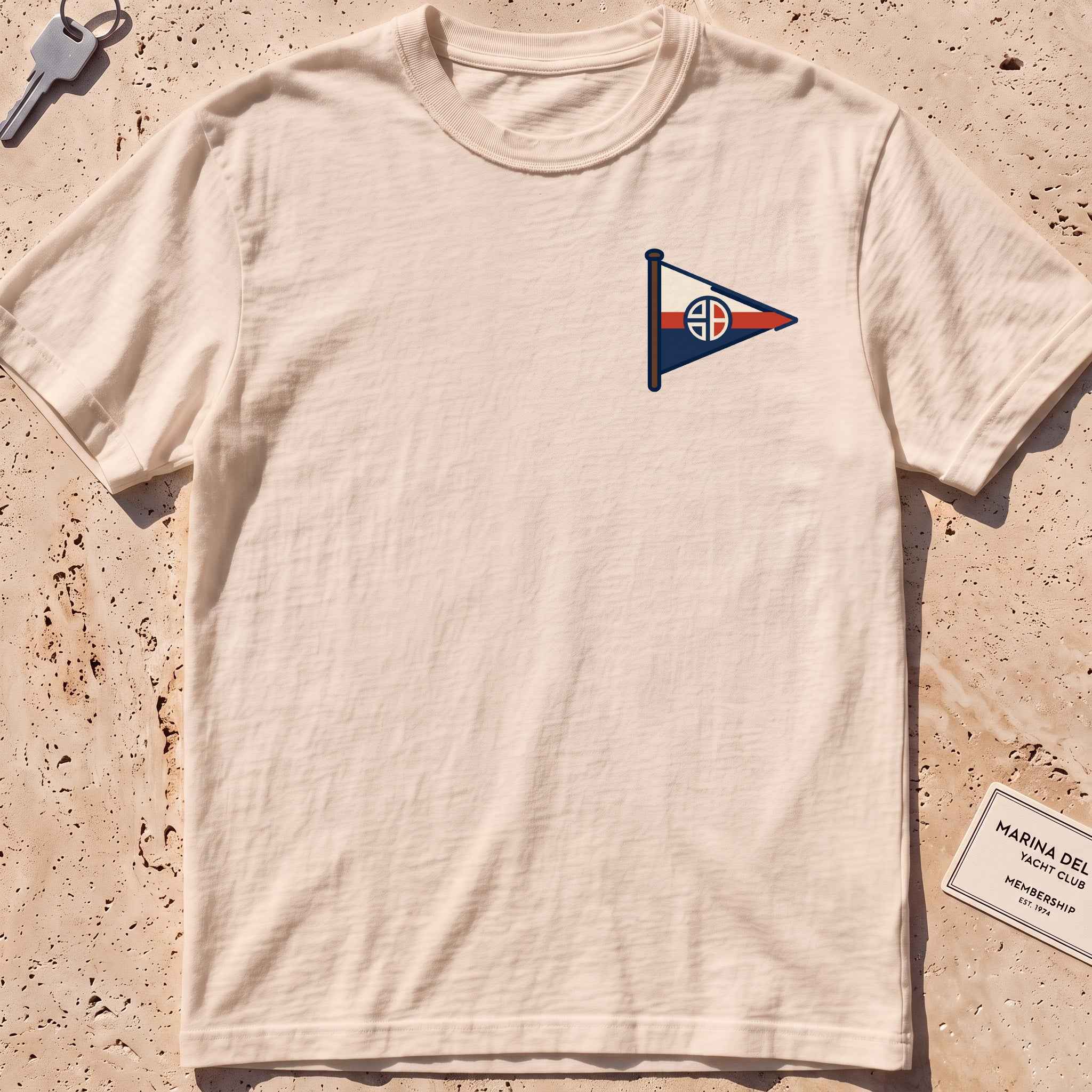 ivory heavyweight tee with a sailing burgee pennant crest graphic.