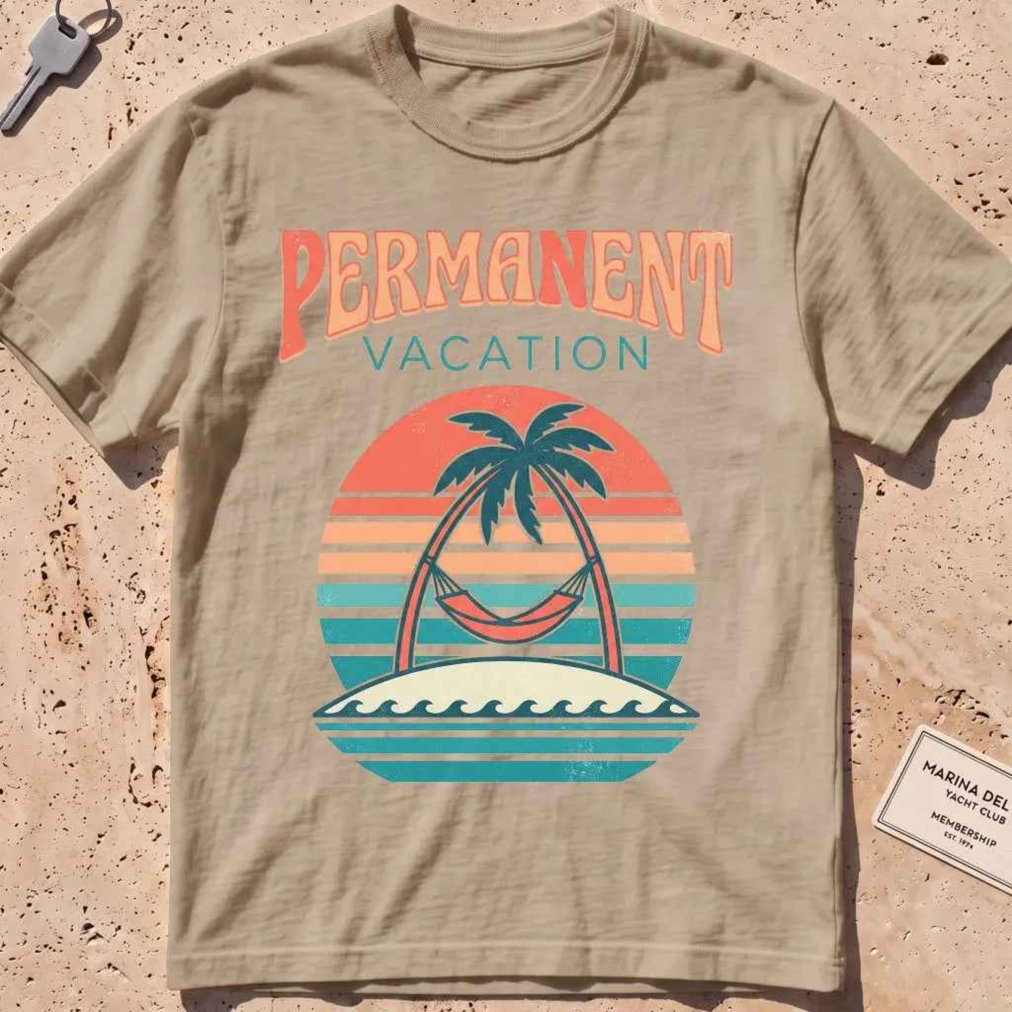 khaki heavyweight tee with a retro sunset and hammock "Permanent Vacation" graphic.