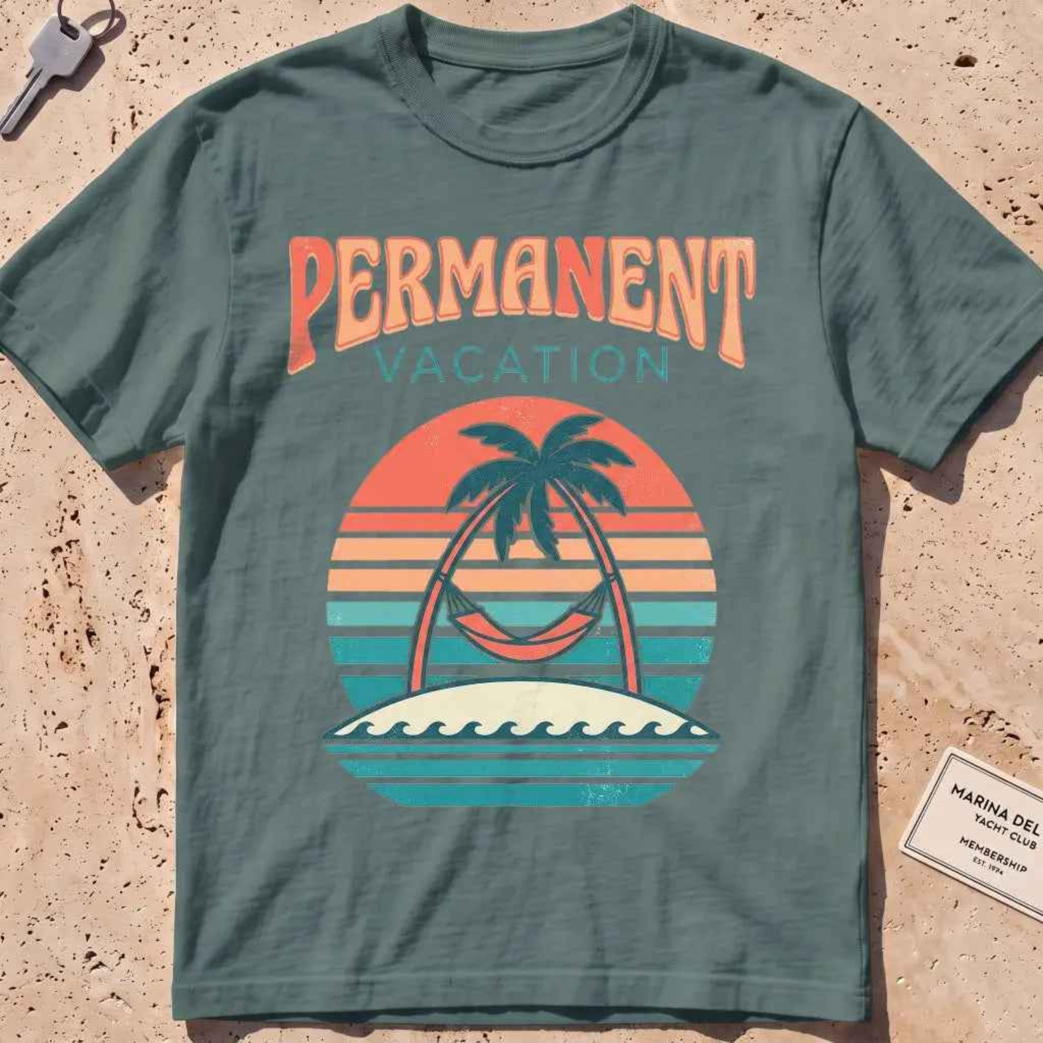 blue spruce heavyweight tee with a retro sunset and hammock "Permanent Vacation" graphic.