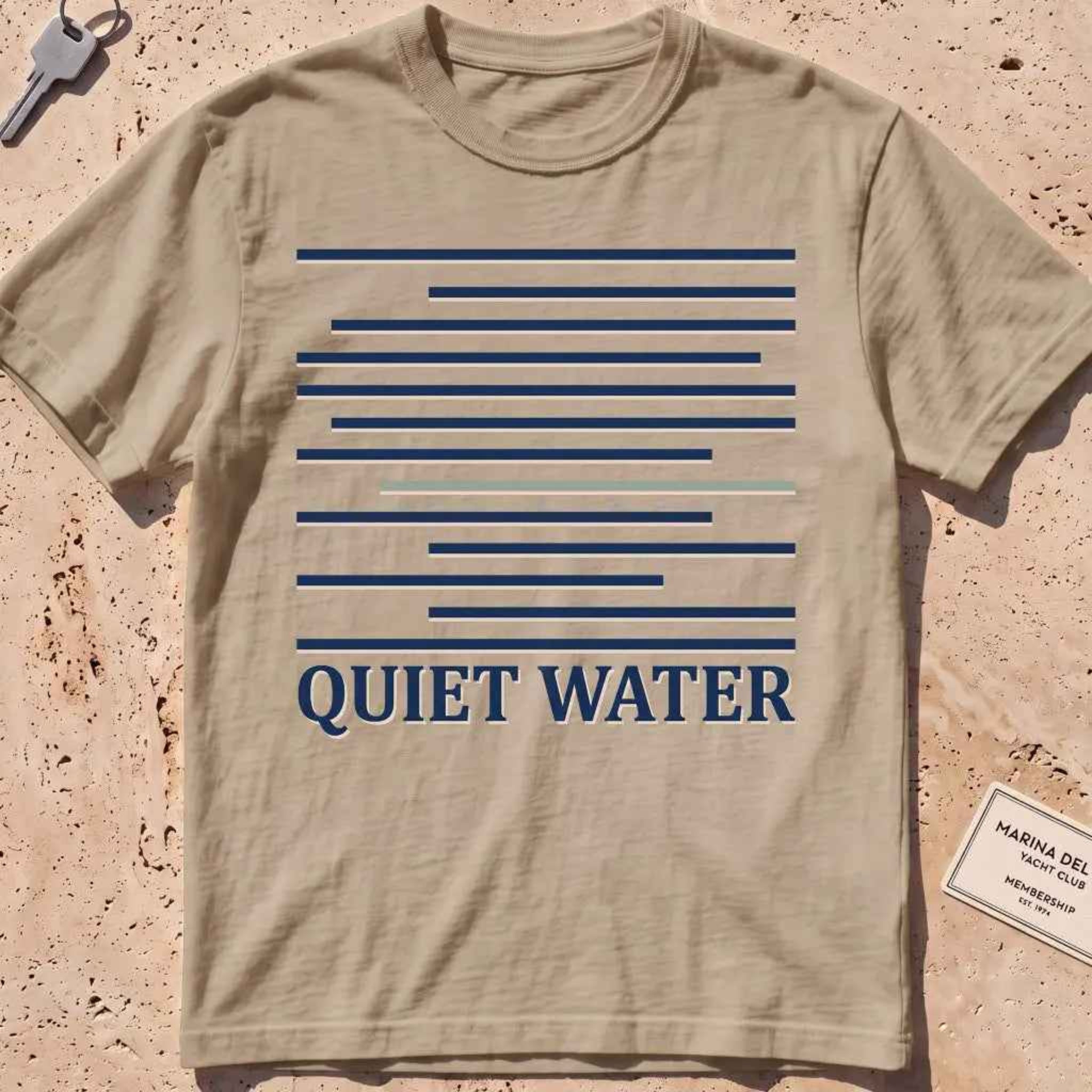 khaki heavyweight tee with still-water lines and "Quiet Water" type.