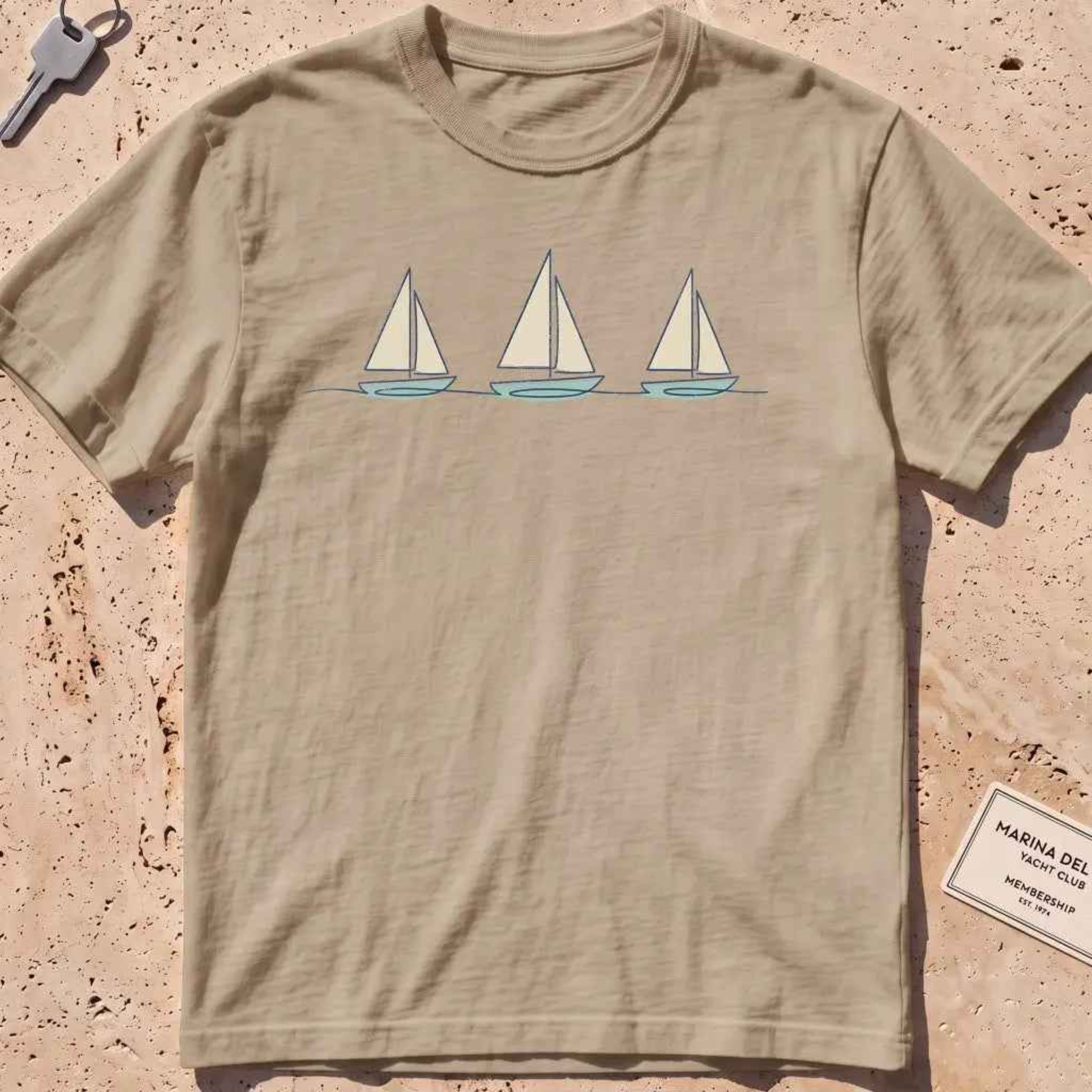 khaki heavyweight tee with three sailboats on a low horizon graphic.