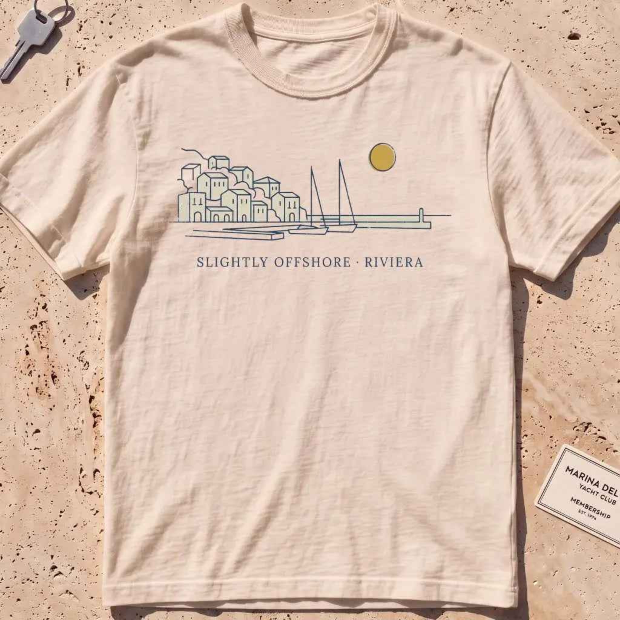 ivory heavyweight tee with a single-line harbor skyline and mustard sun.