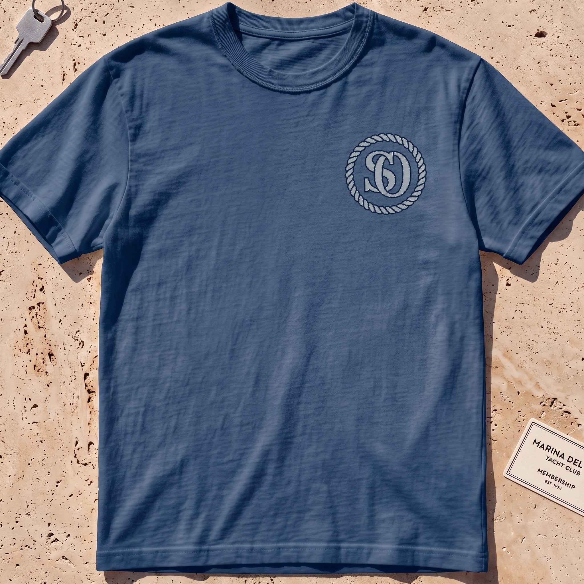 midnight heavyweight tee with a rope-ring SO monogram crest graphic.