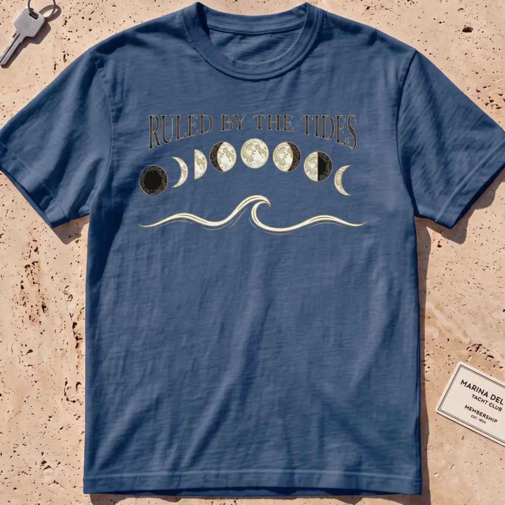 midnight heavyweight tee with moon phases, a wave and "Ruled by the Tides" text.