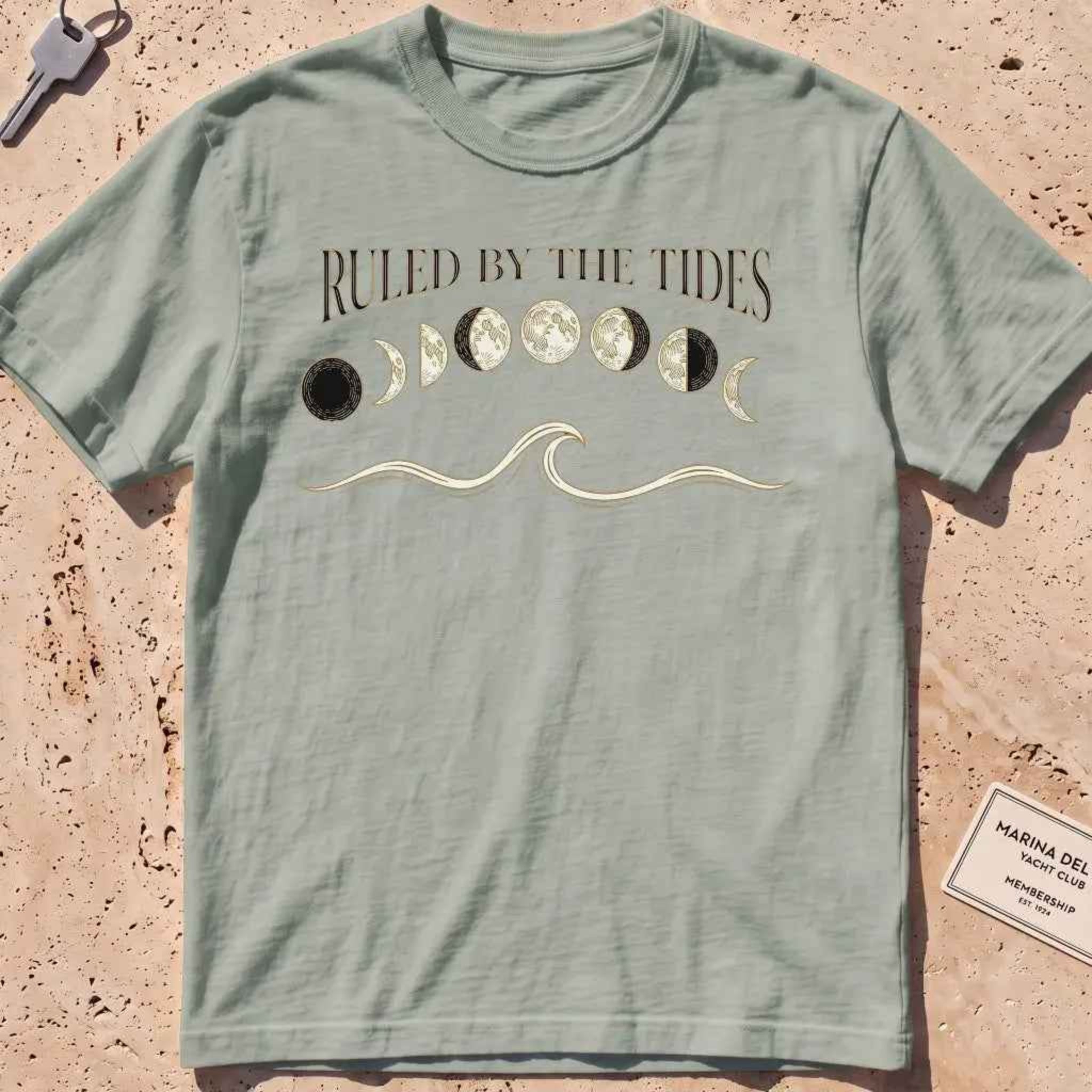 bay heavyweight tee with moon phases, a wave and "Ruled by the Tides" text.