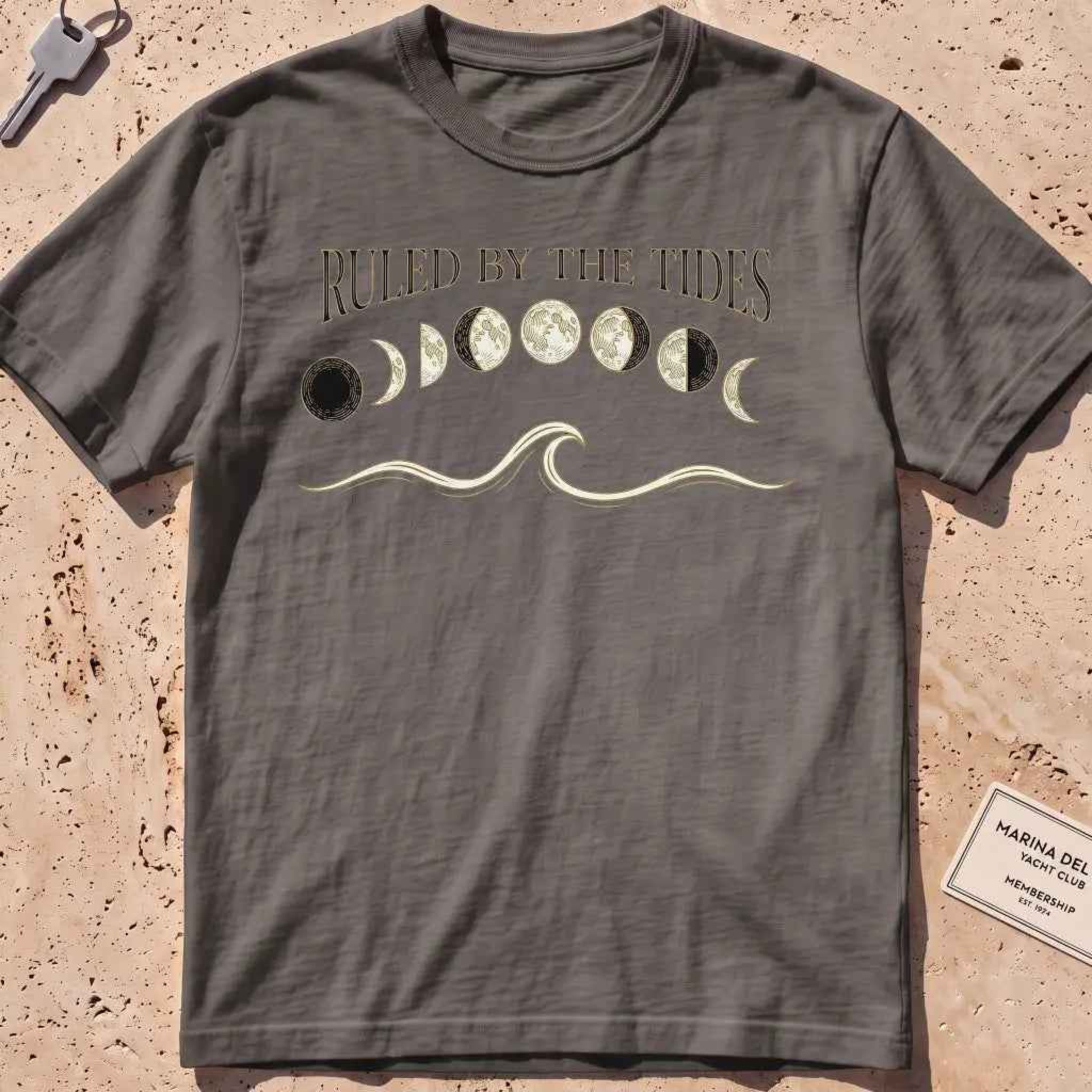 pepper heavyweight tee with moon phases, a wave and "Ruled by the Tides" text.