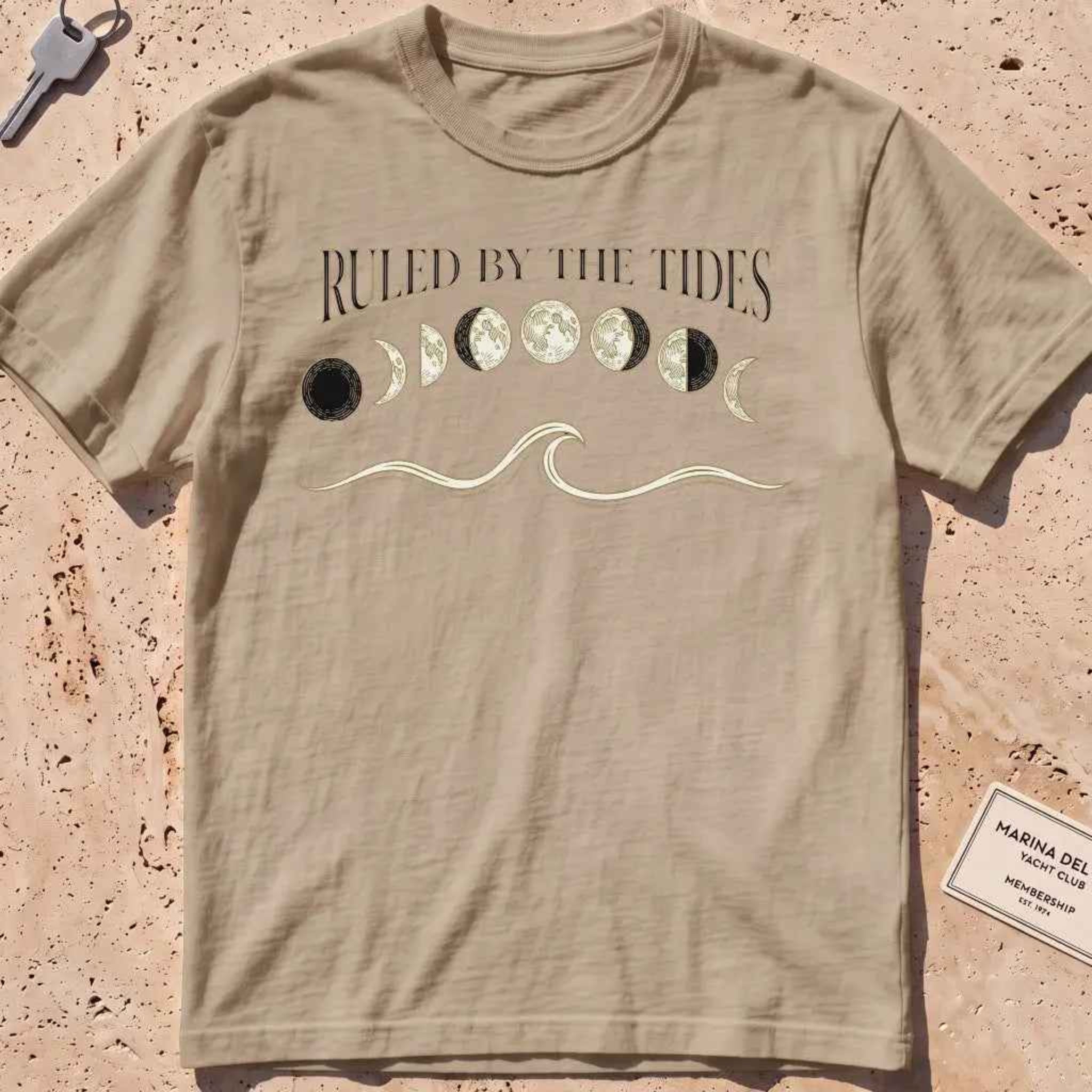 khaki heavyweight tee with moon phases, a wave and "Ruled by the Tides" text.