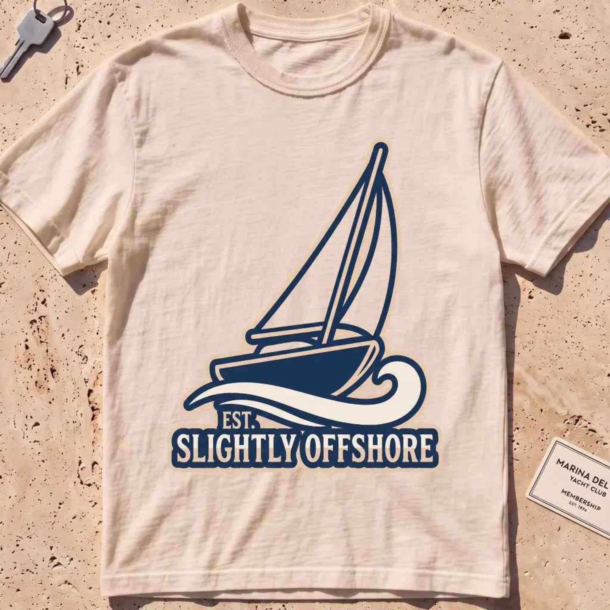 ivory heavyweight tee with a sailboat heeling into the wind, "Sail Away" graphic.