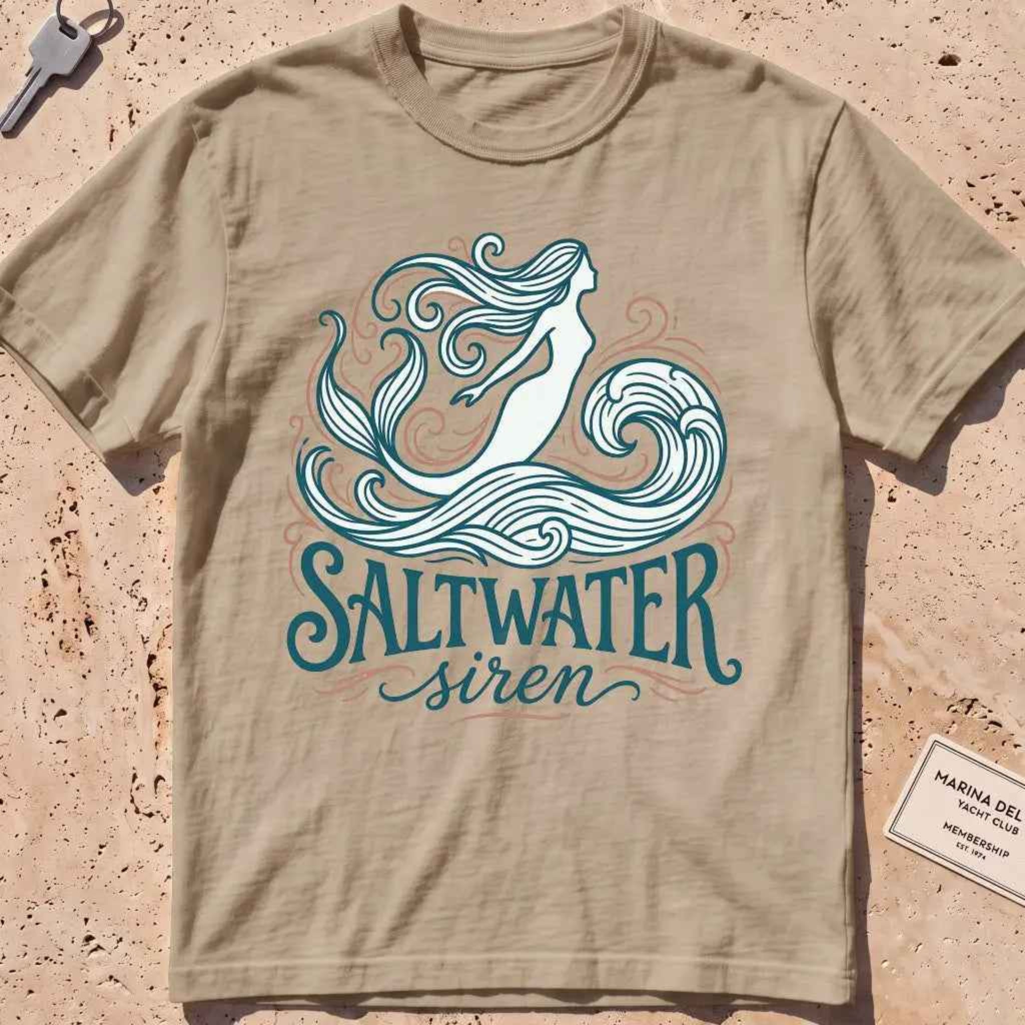 khaki heavyweight tee with a mermaid line-art "Saltwater Siren" graphic.