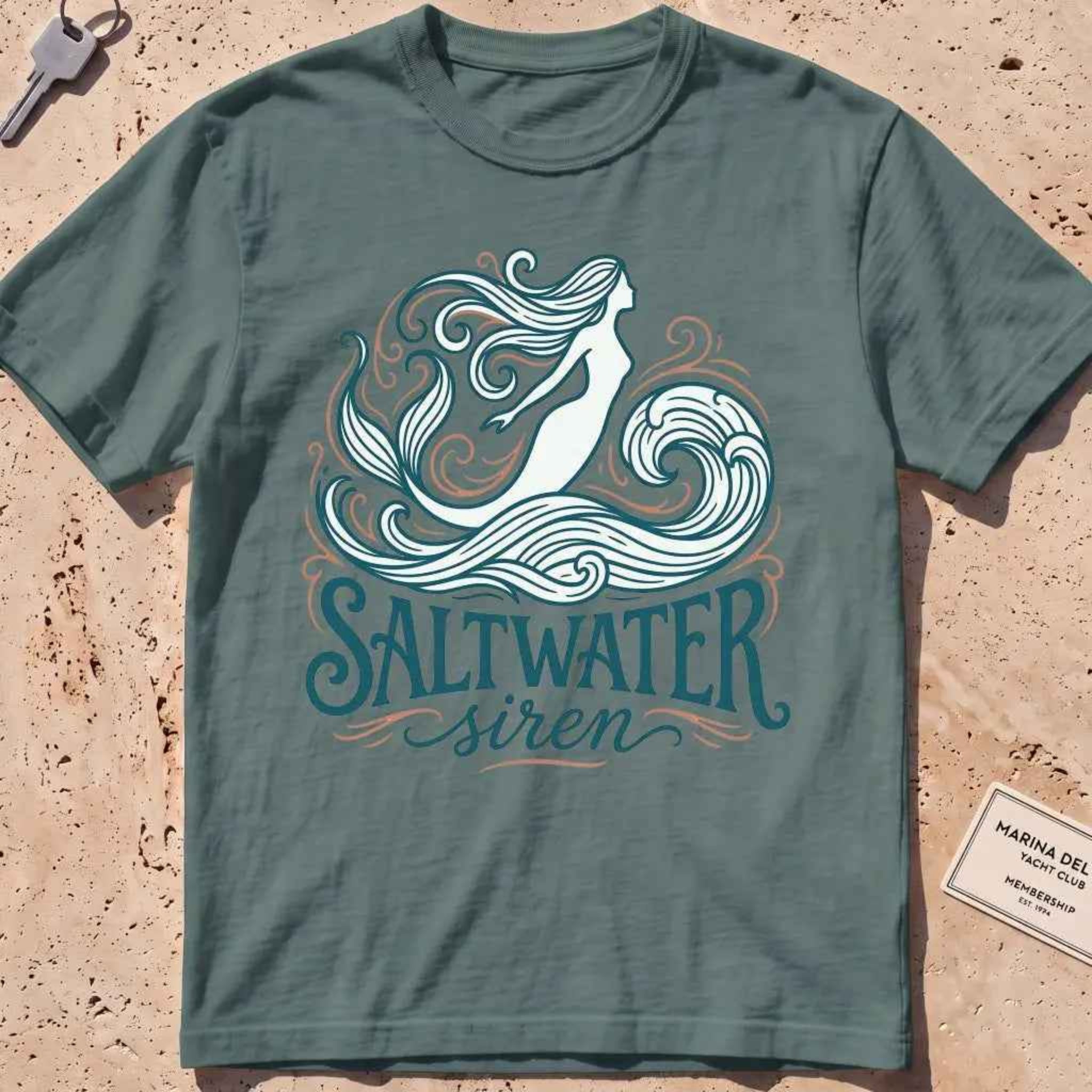 blue spruce heavyweight tee with a mermaid line-art "Saltwater Siren" graphic.
