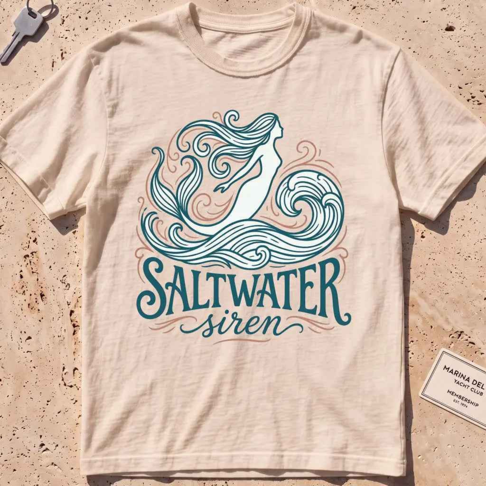 ivory heavyweight tee with a mermaid line-art "Saltwater Siren" graphic.