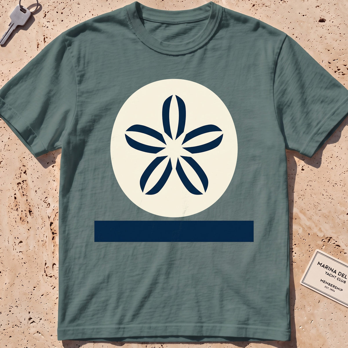 blue spruce heavyweight tee with a flat-geometric sand dollar graphic.