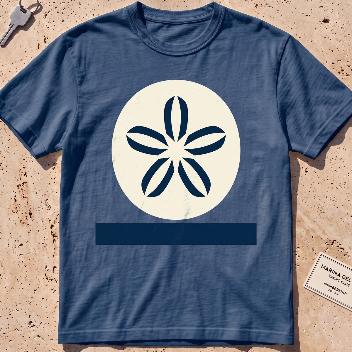 midnight heavyweight tee with a flat-geometric sand dollar graphic.