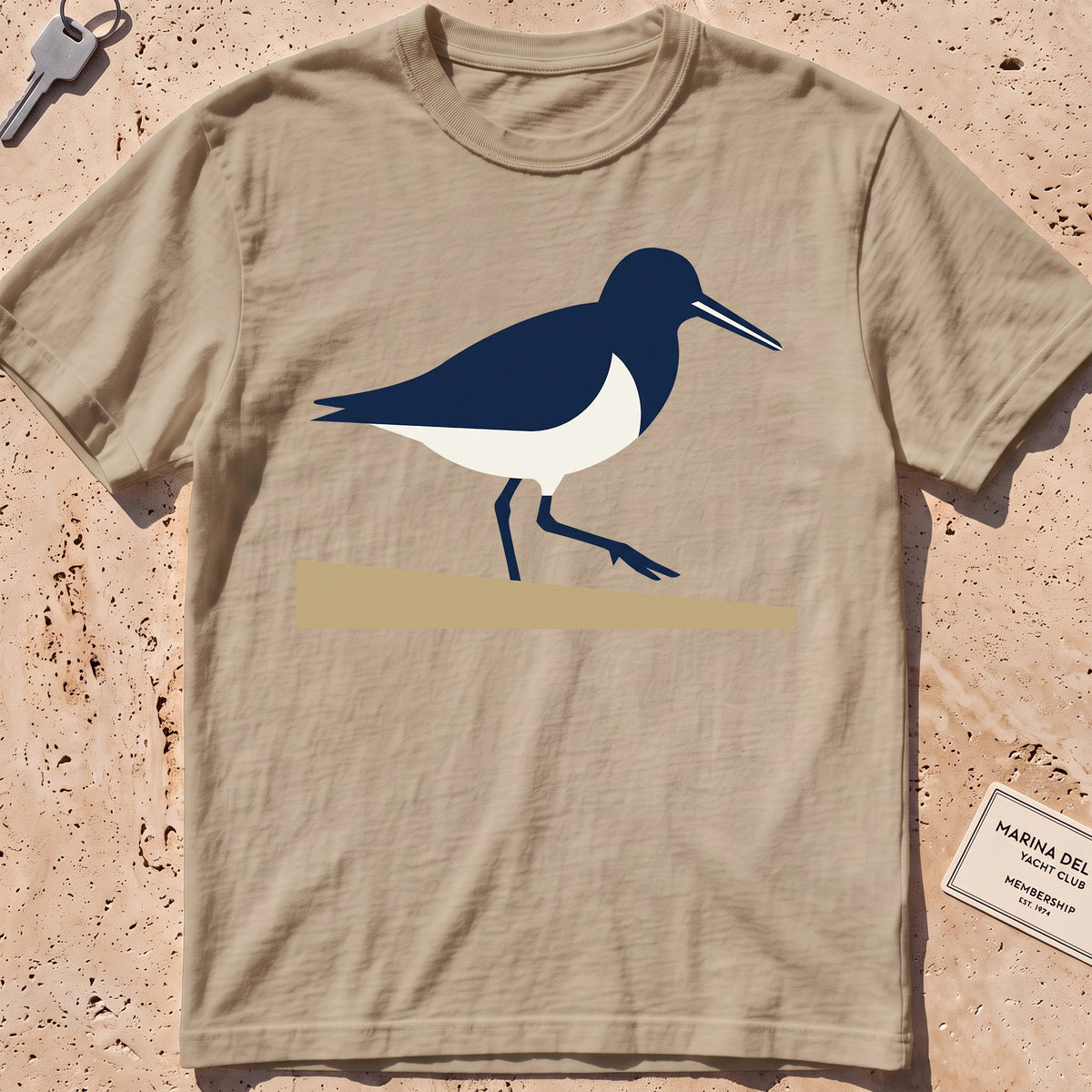 khaki heavyweight tee with a flat-geometric sandpiper graphic.