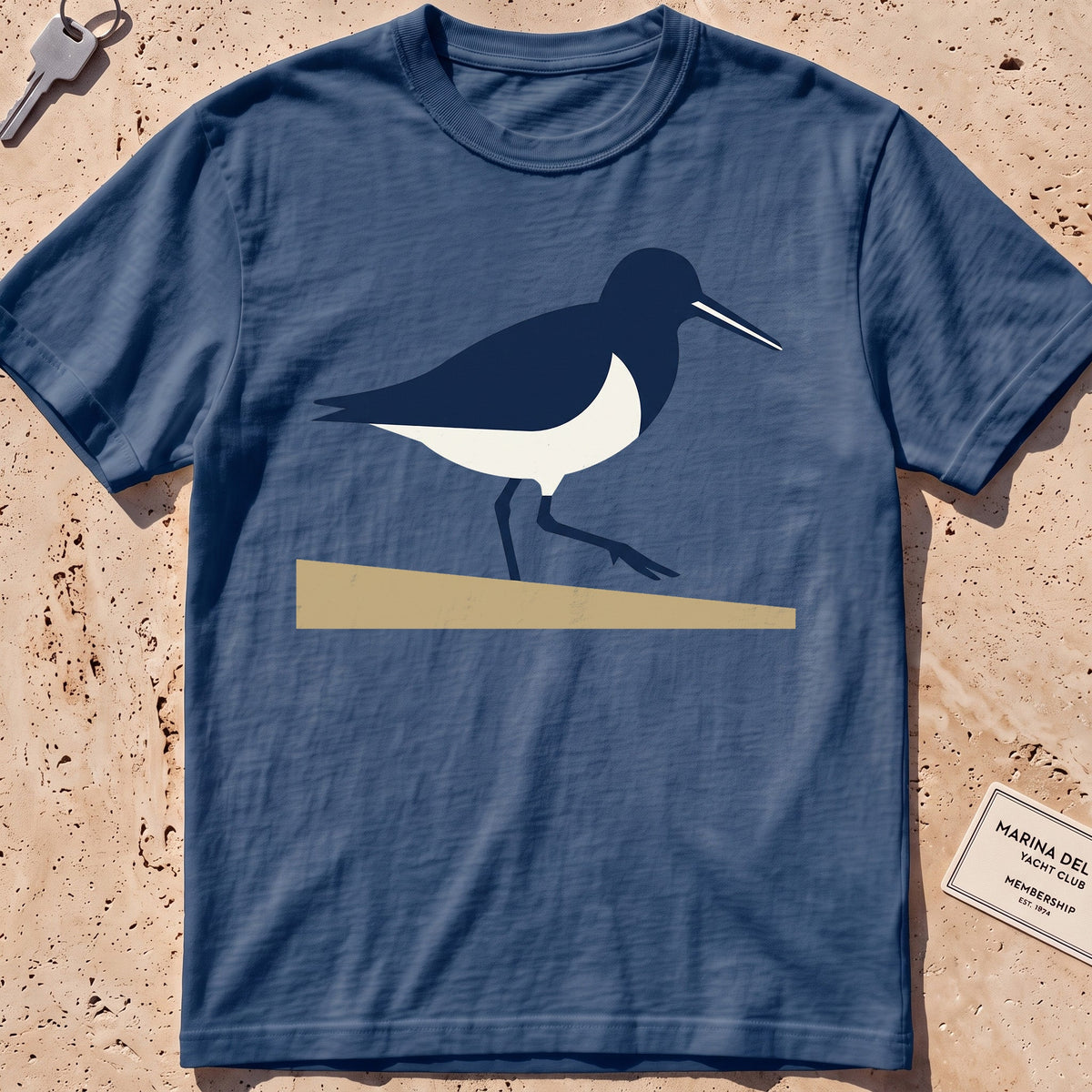 midnight heavyweight tee with a flat-geometric sandpiper graphic.