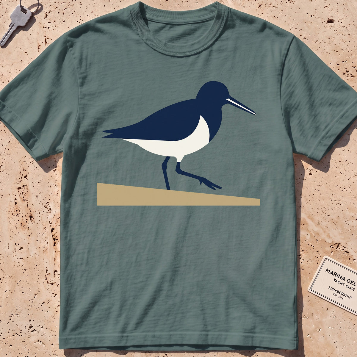 blue spruce heavyweight tee with a flat-geometric sandpiper graphic.