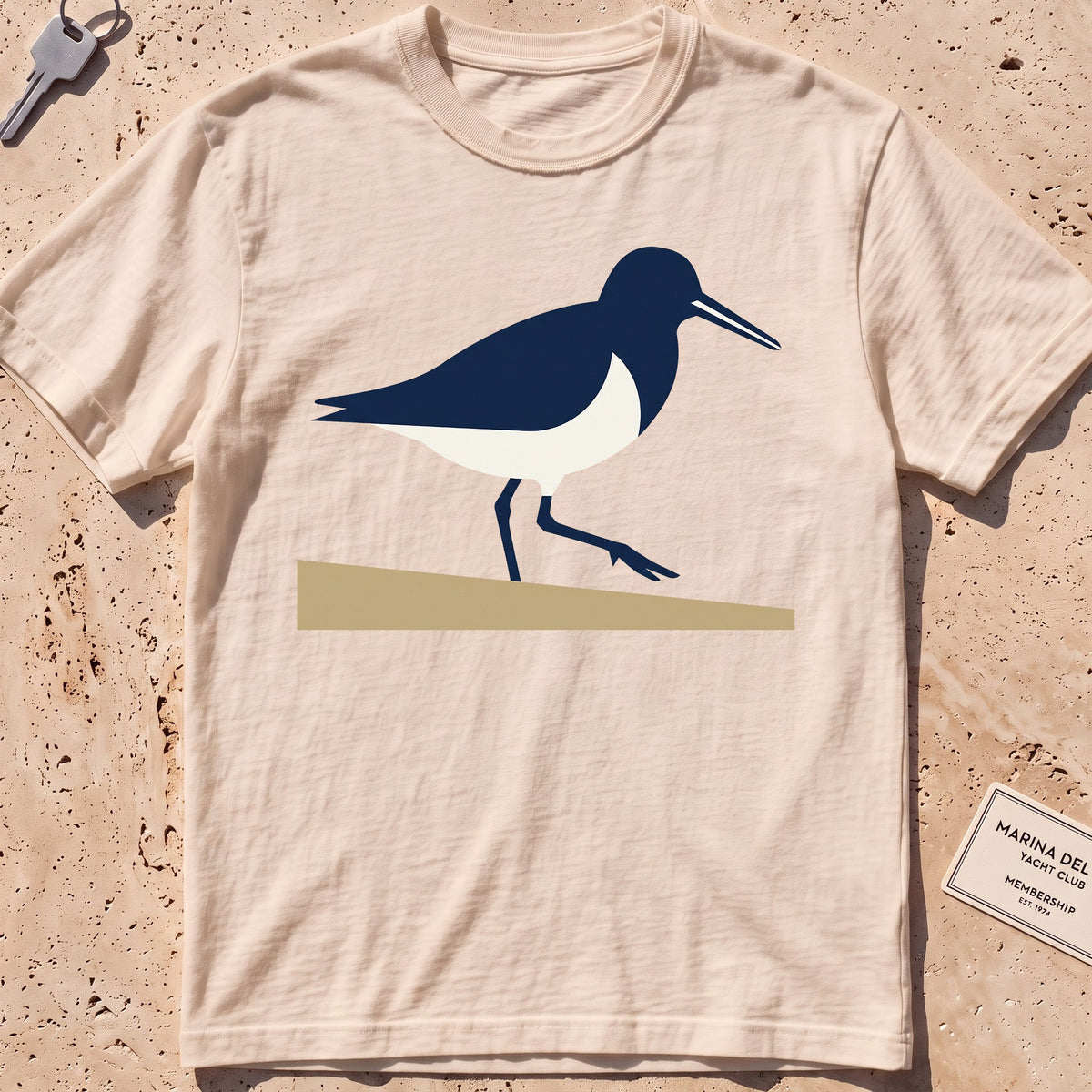 ivory heavyweight tee with a flat-geometric sandpiper graphic.