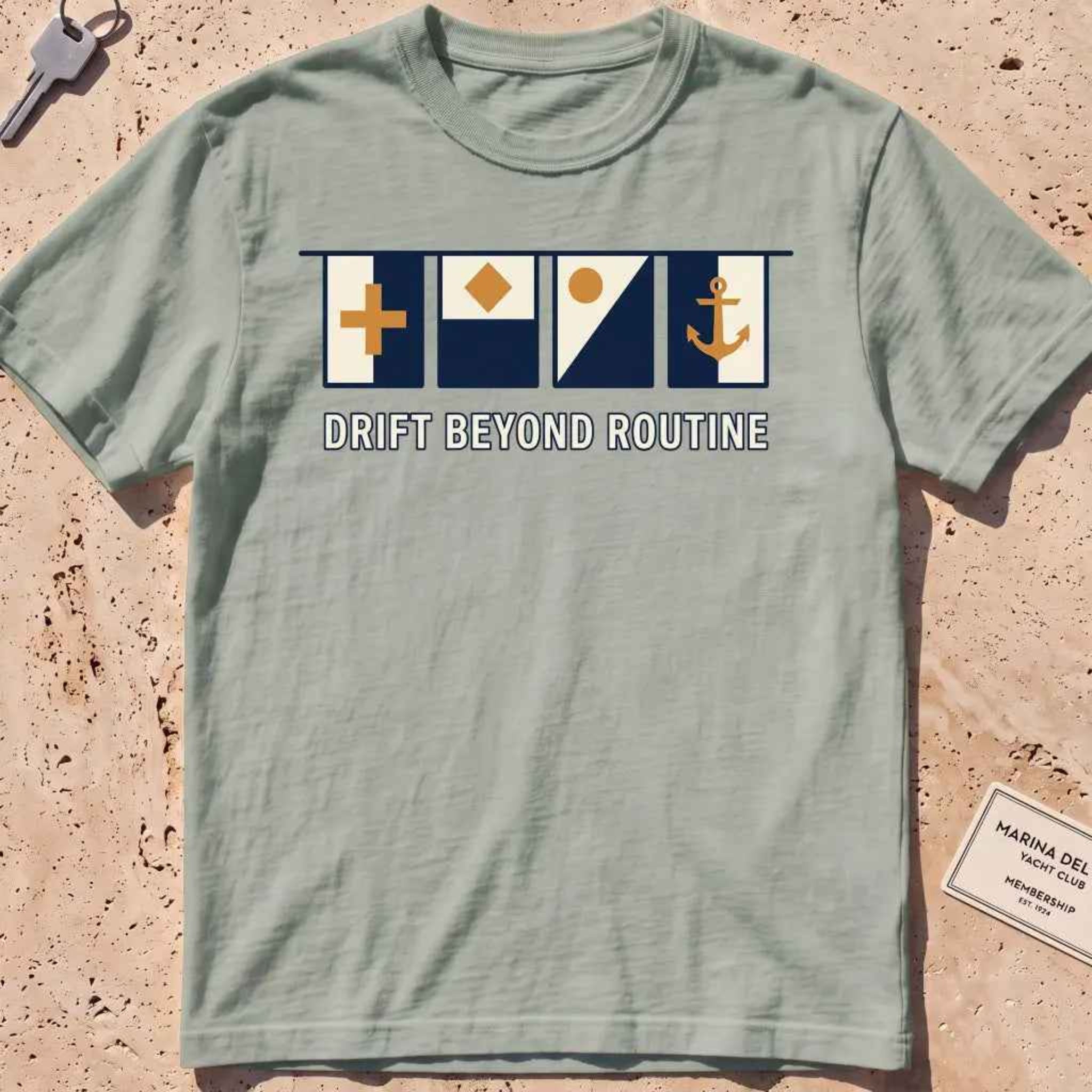 bay heavyweight tee with maritime signal flags and "Drift Beyond Routine" text.