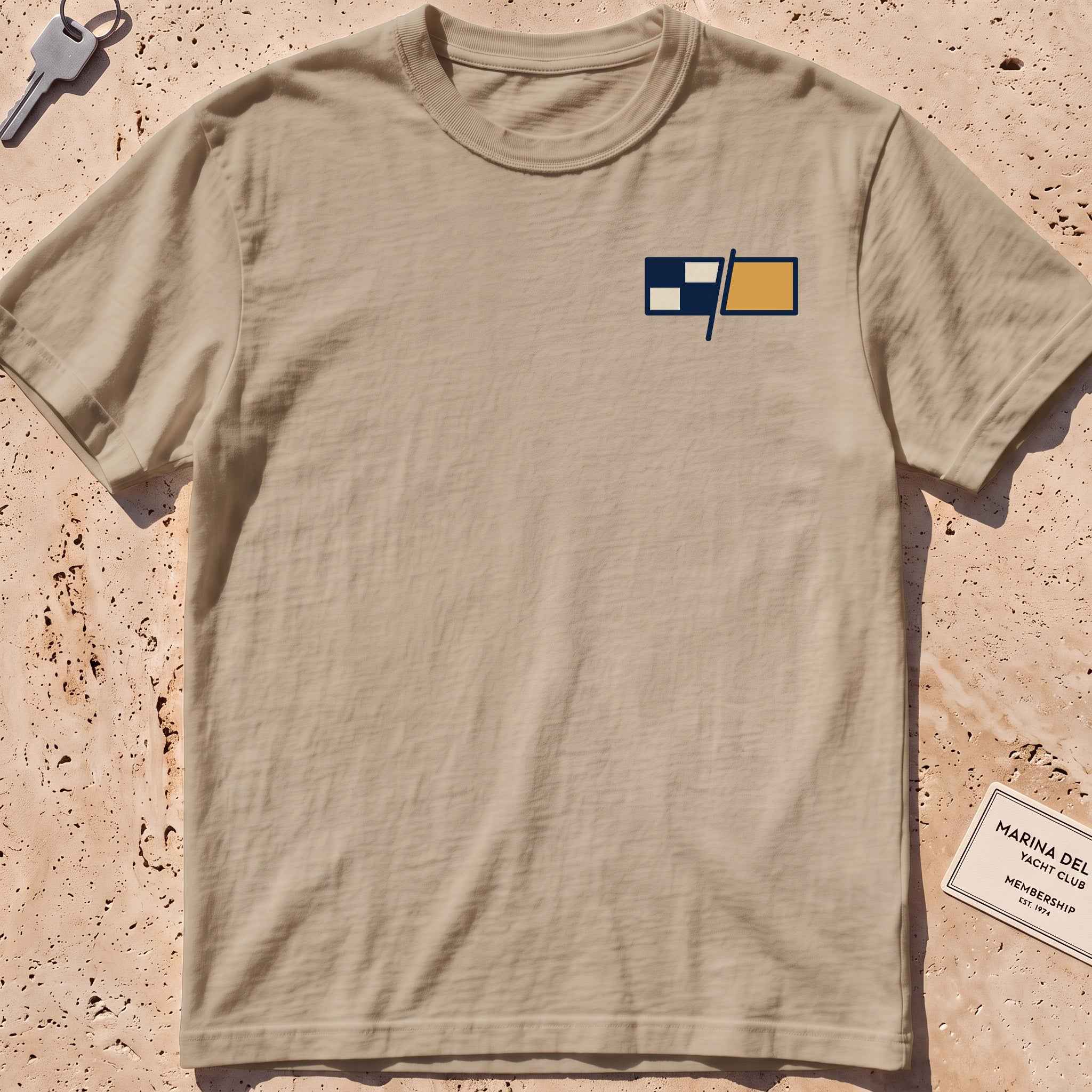 khaki heavyweight tee with a pair of maritime signal flags crest graphic.