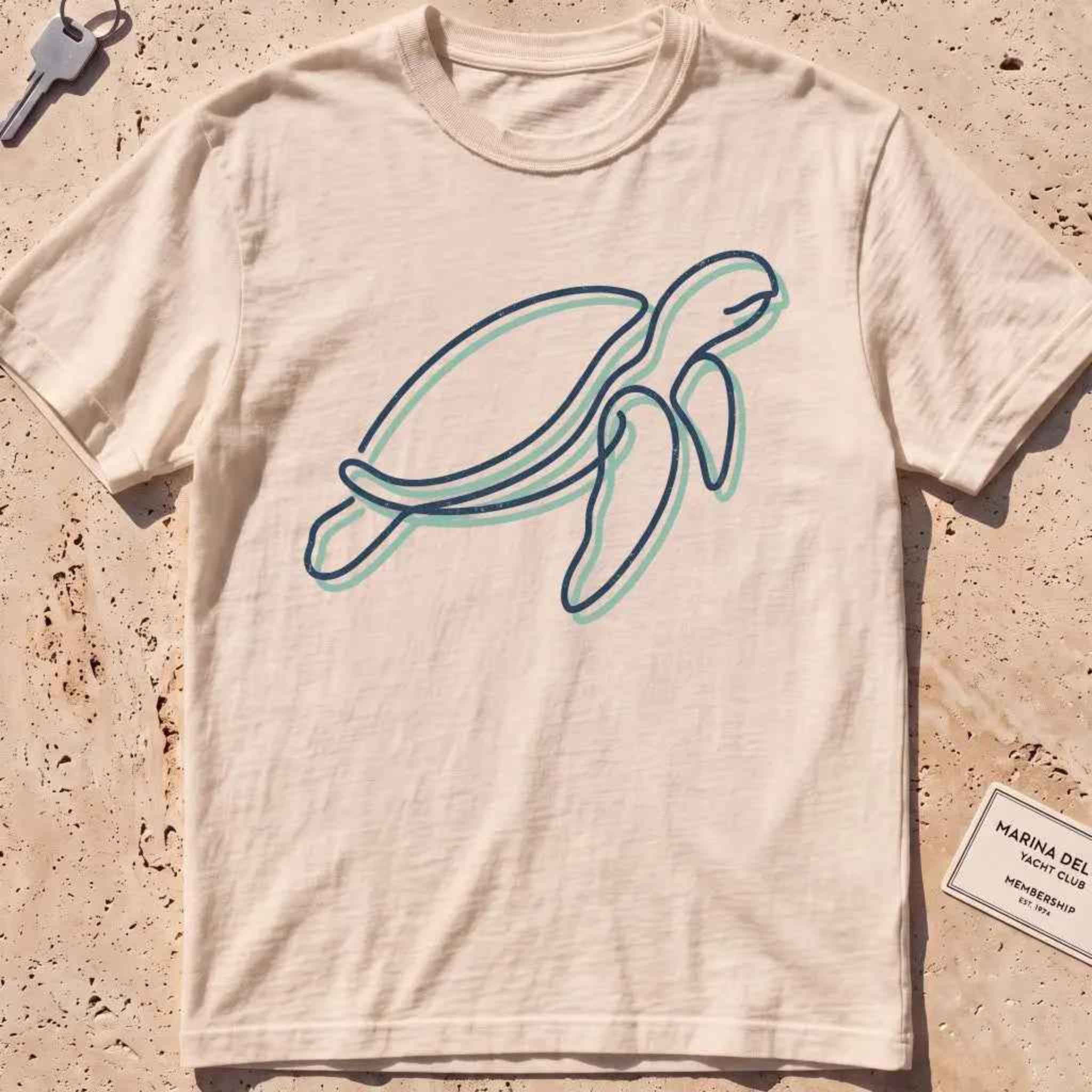 ivory heavyweight tee with a single continuous-line sea turtle graphic.
