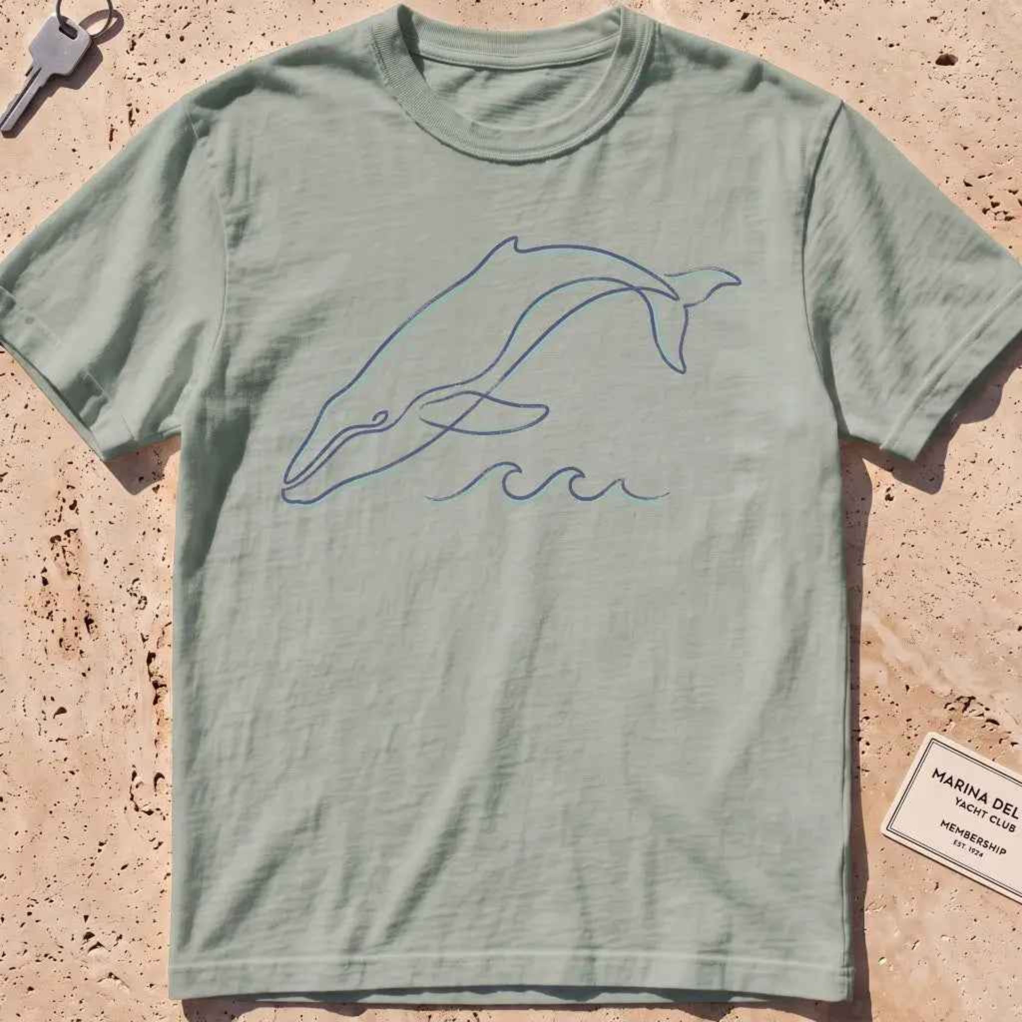 bay heavyweight tee with a single continuous-line whale and wave graphic.