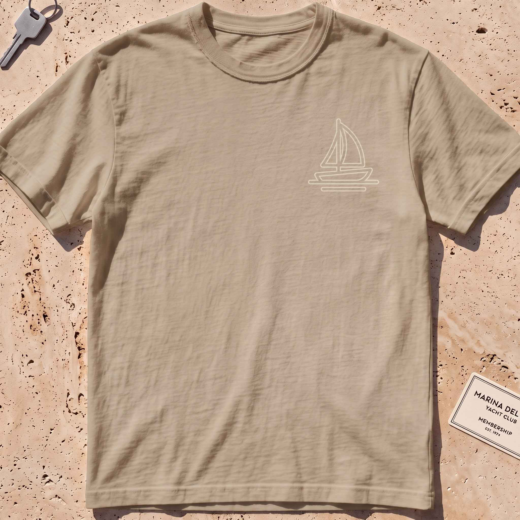 khaki heavyweight tee with a single-line lone sail crest graphic.