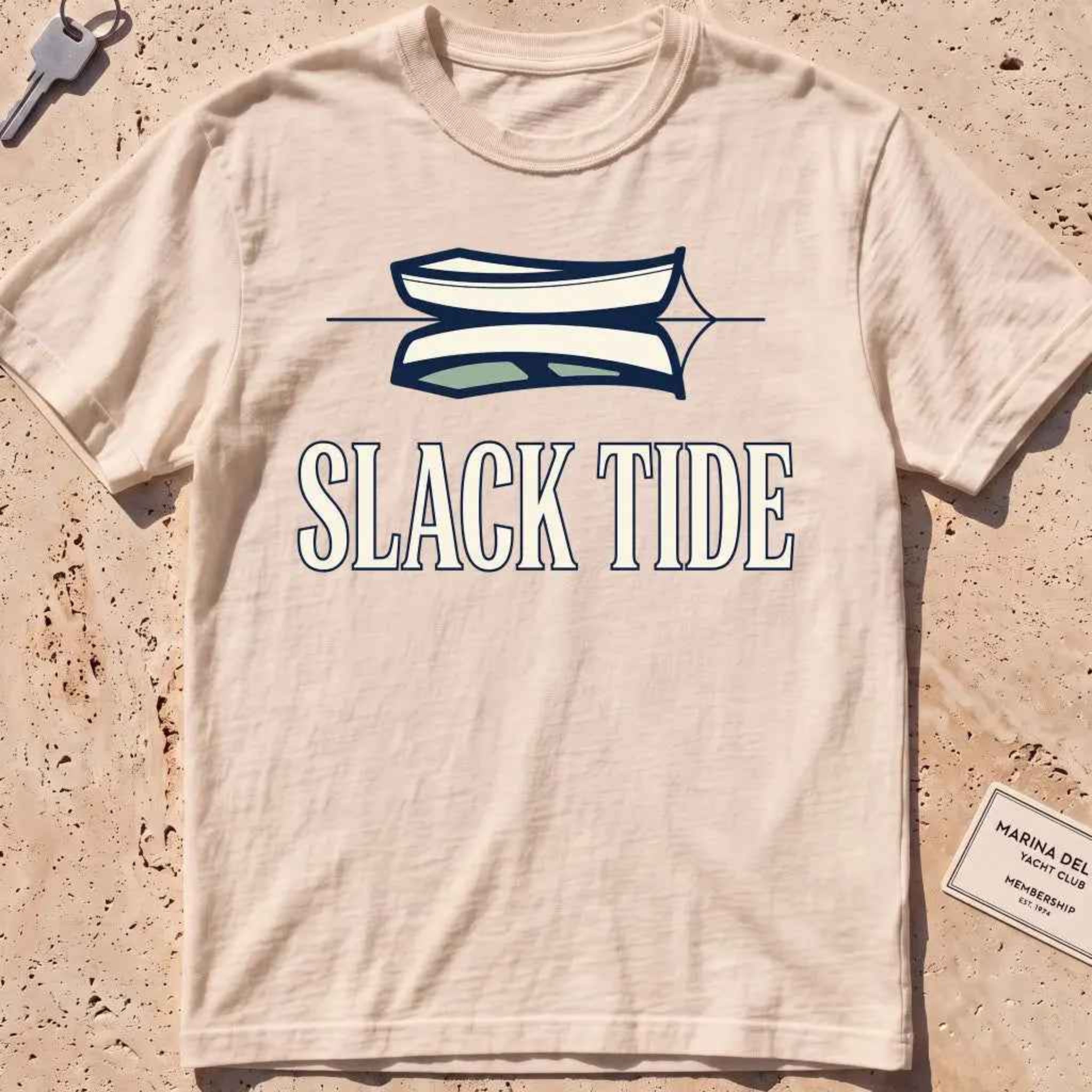 ivory heavyweight tee with a moored dinghy and still-water reflection graphic.