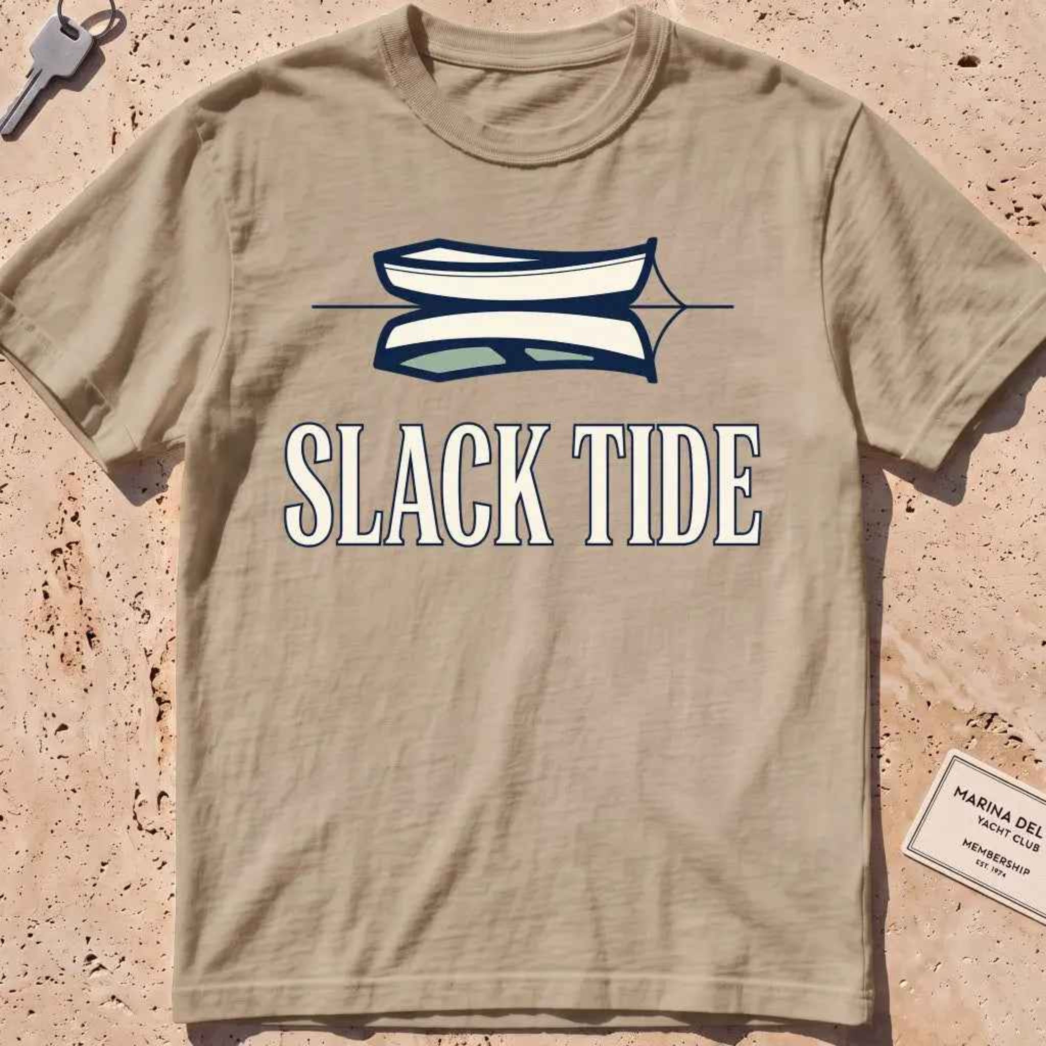 khaki heavyweight tee with a moored dinghy and still-water reflection graphic.