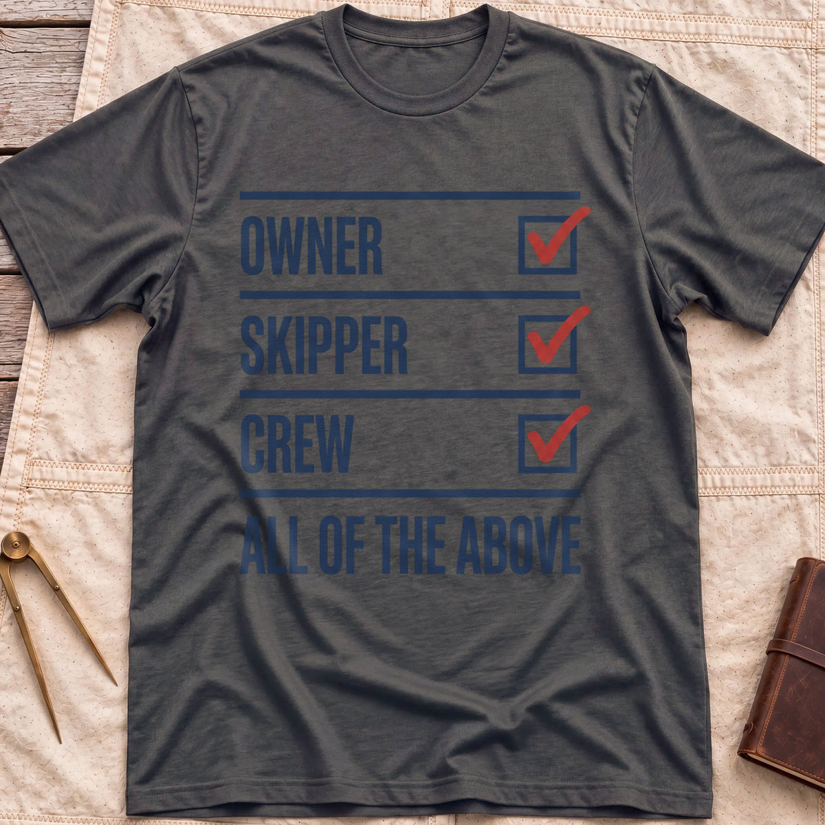 Front view of the dark heather All of the Above T-Shirt with a checklist of Owner, Skipper and Crew, each ticked in red, above All of the Above.