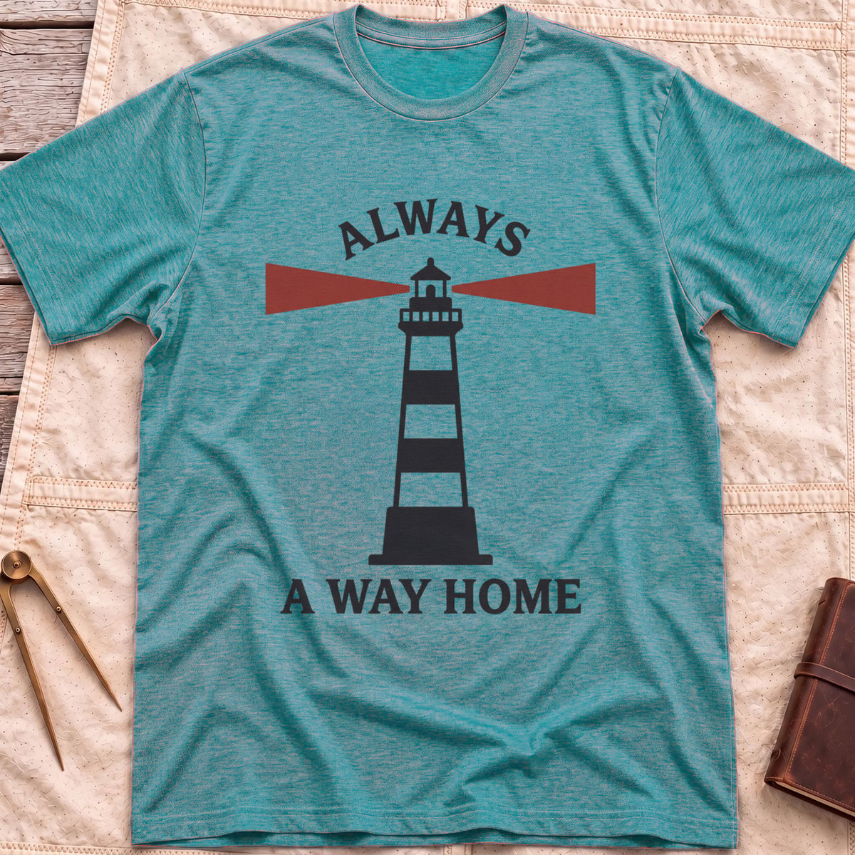 Front view of the heather galapagos blue Always a Way Home T-Shirt with a striped lighthouse sending out red beams of light.