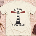 Front view of the natural Always a Way Home T-Shirt with a striped lighthouse sending out red beams of light.