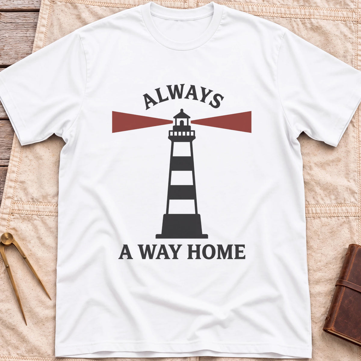 Front view of the white Always a Way Home T-Shirt with a striped lighthouse sending out red beams of light.