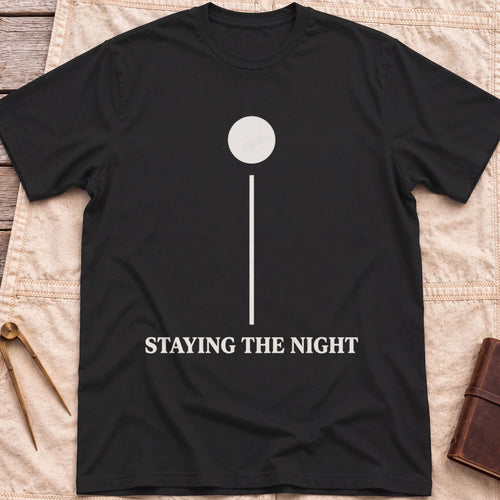 Front view of the black Anchor Light T-Shirt with a single round light on a tall vertical line above the words Staying the Night.