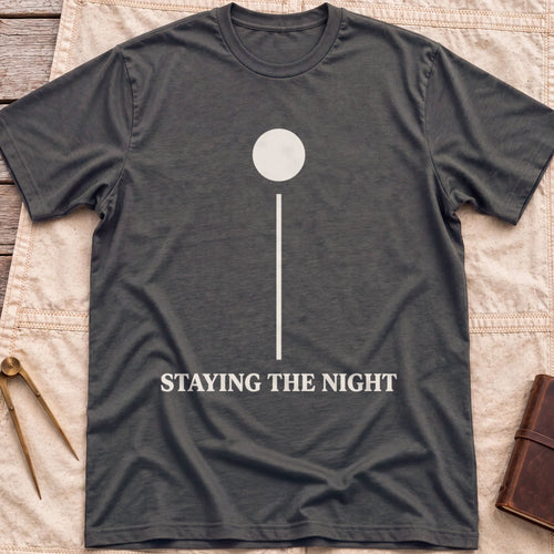 Front view of the dark heather Anchor Light T-Shirt with a single round light on a tall vertical line above the words Staying the Night.