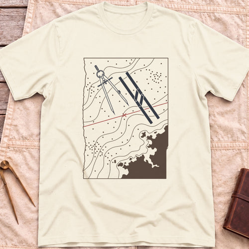 Front view of the natural Chart Table T-Shirt with a chart showing contour lines, dividers, parallel rulers and a red course line.