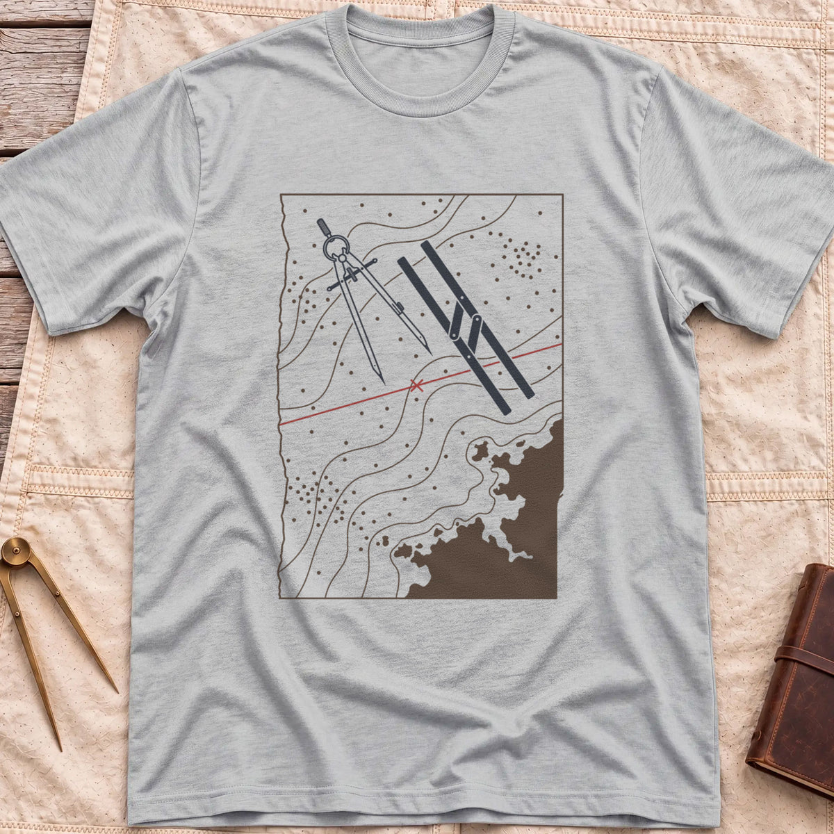 Front view of the sport grey Chart Table T-Shirt with a chart showing contour lines, dividers, parallel rulers and a red course line.