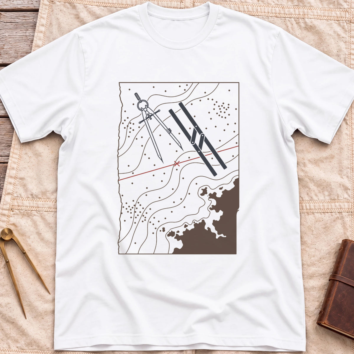 Front view of the white Chart Table T-Shirt with a chart showing contour lines, dividers, parallel rulers and a red course line.