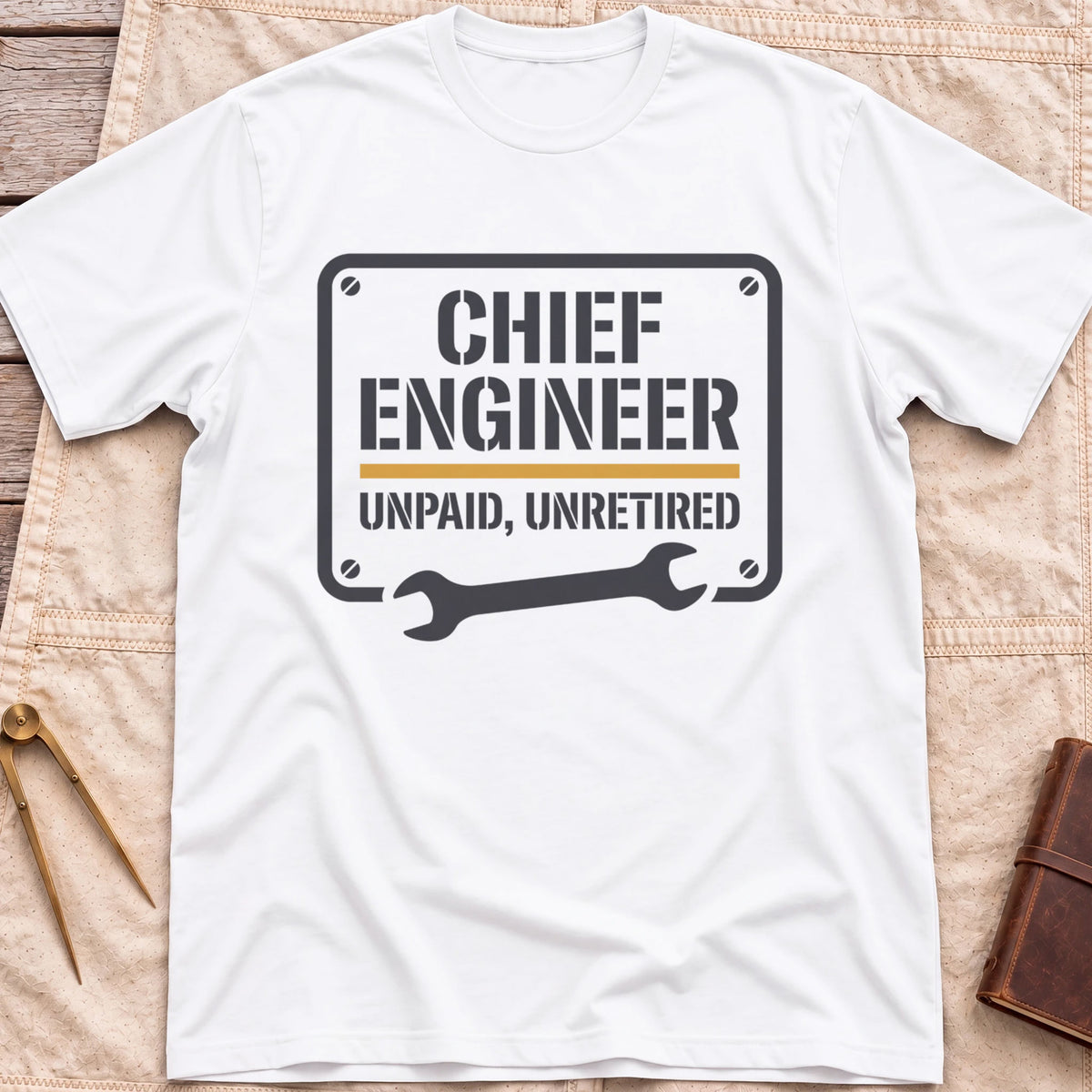 Front view of the white Chief Engineer T-Shirt with a stencil-style plate reading Unpaid, Unretired above a wrench.